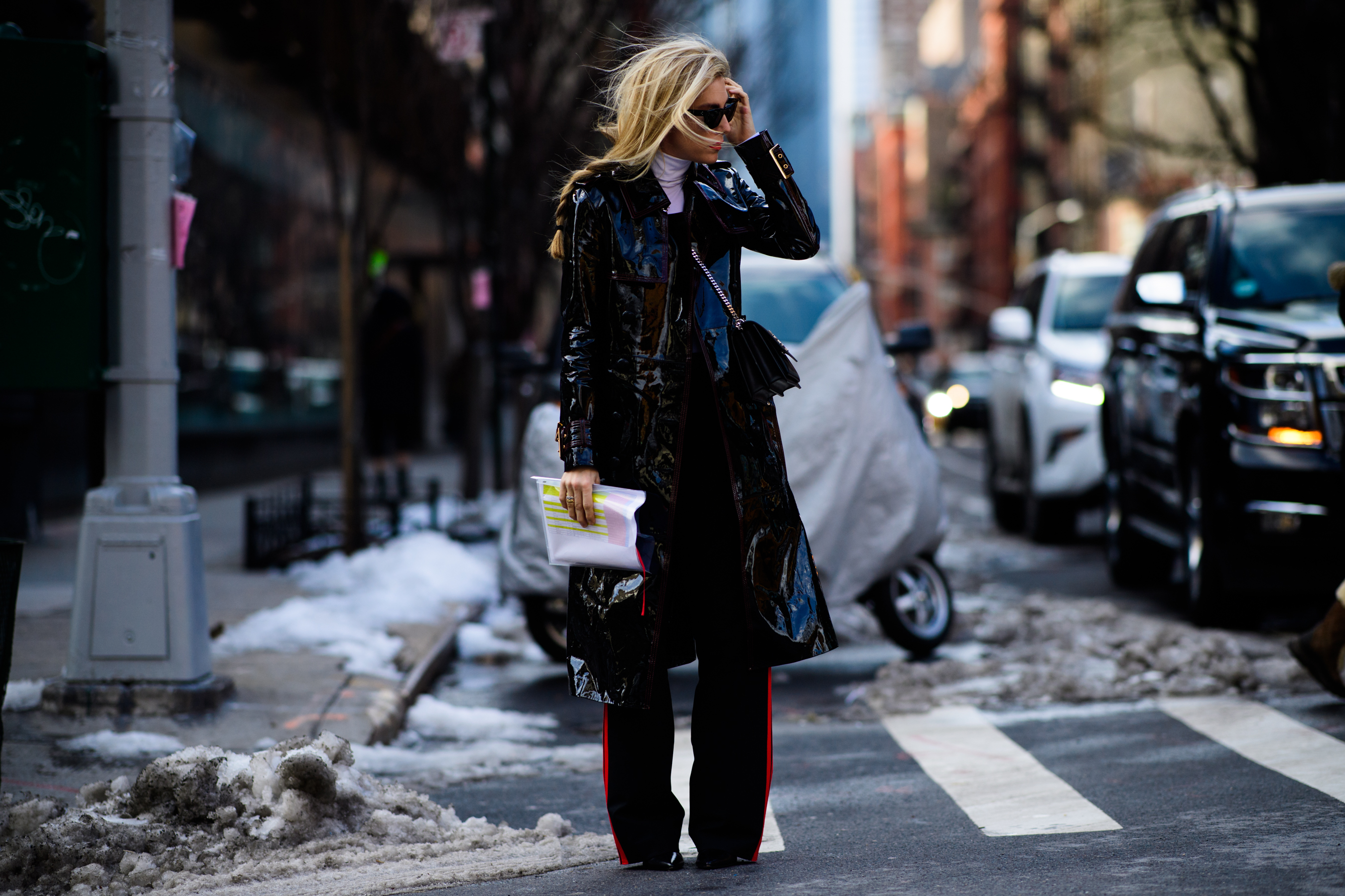 Woman wearing black shiny leather coat