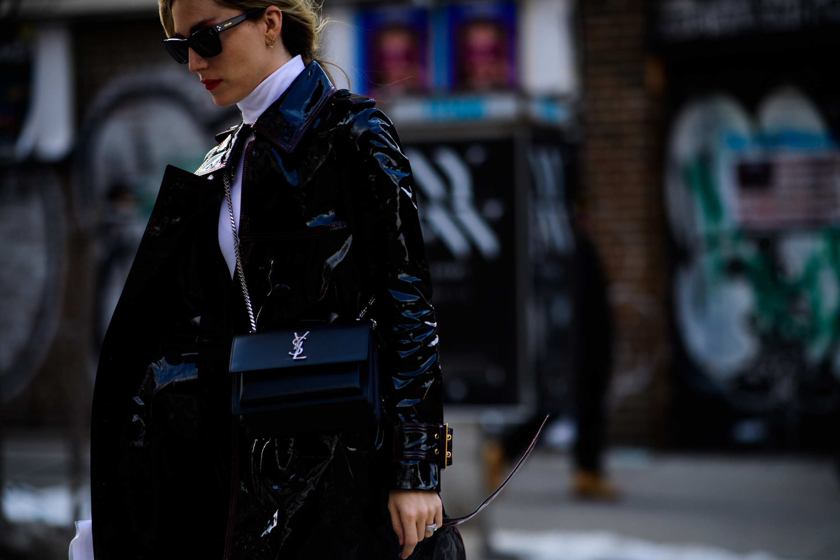 Woman wearing black shiny leather coat