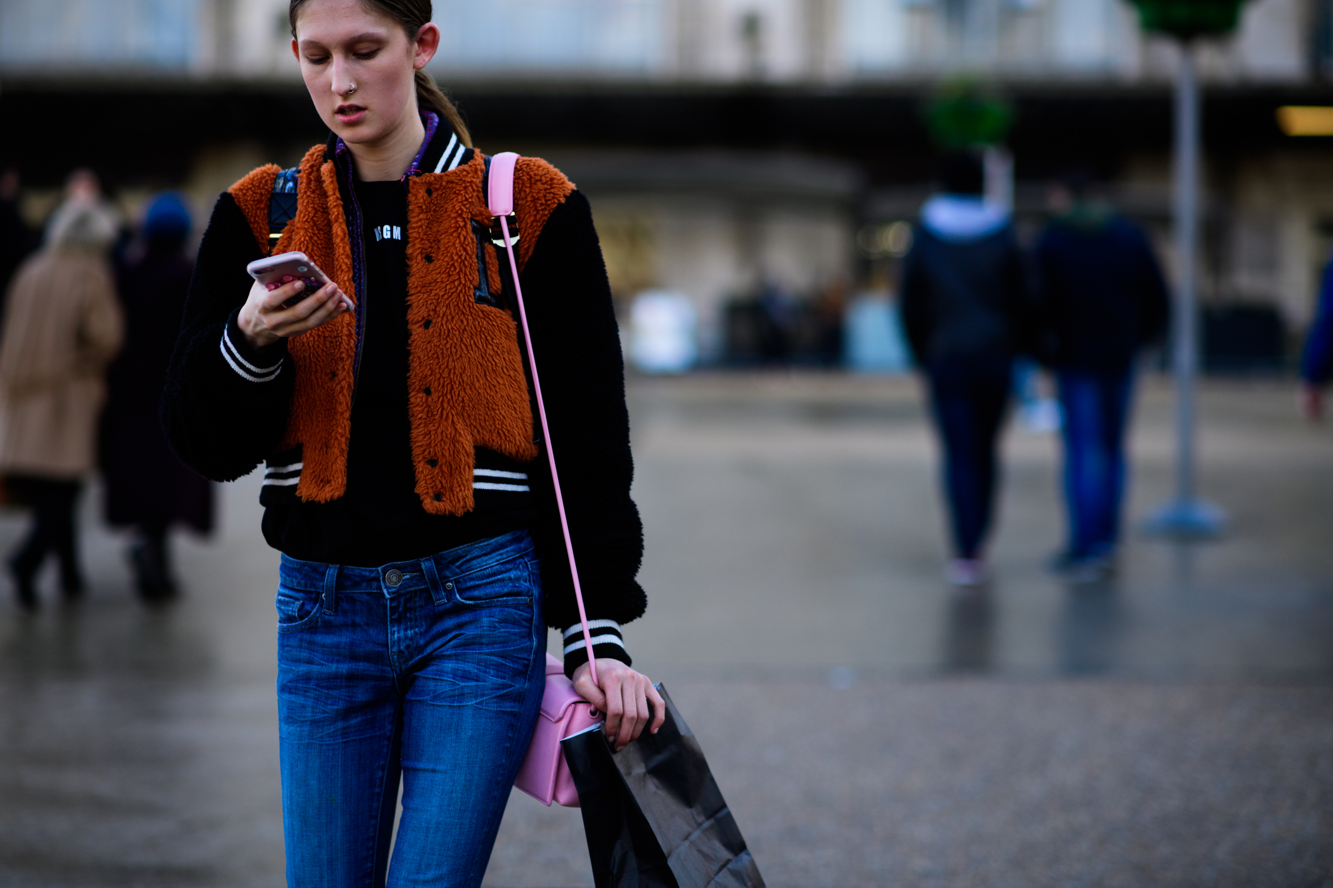 American model wearing varsity bomber jacket