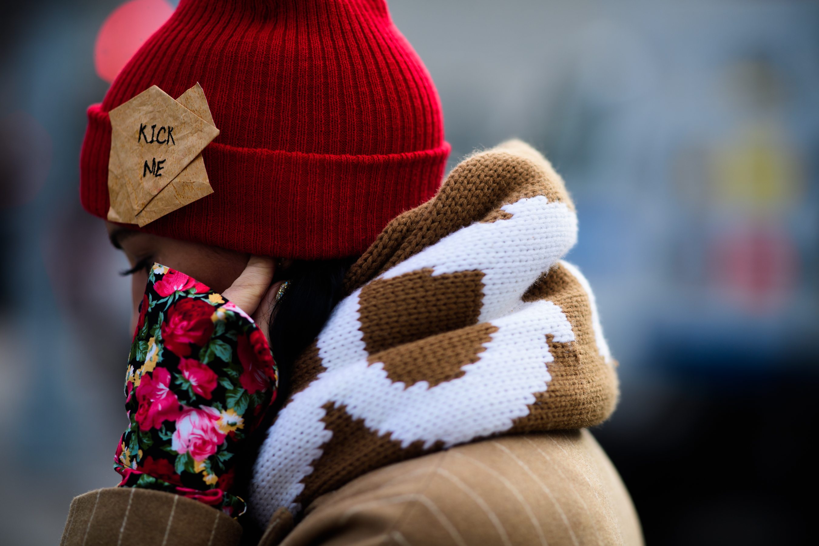 Woman wearing Kick Me on her hat