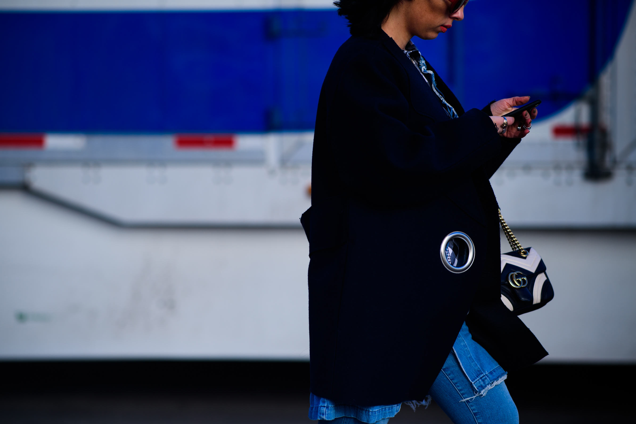 Woman wearing Jacquemus jacket and Gucci handbag