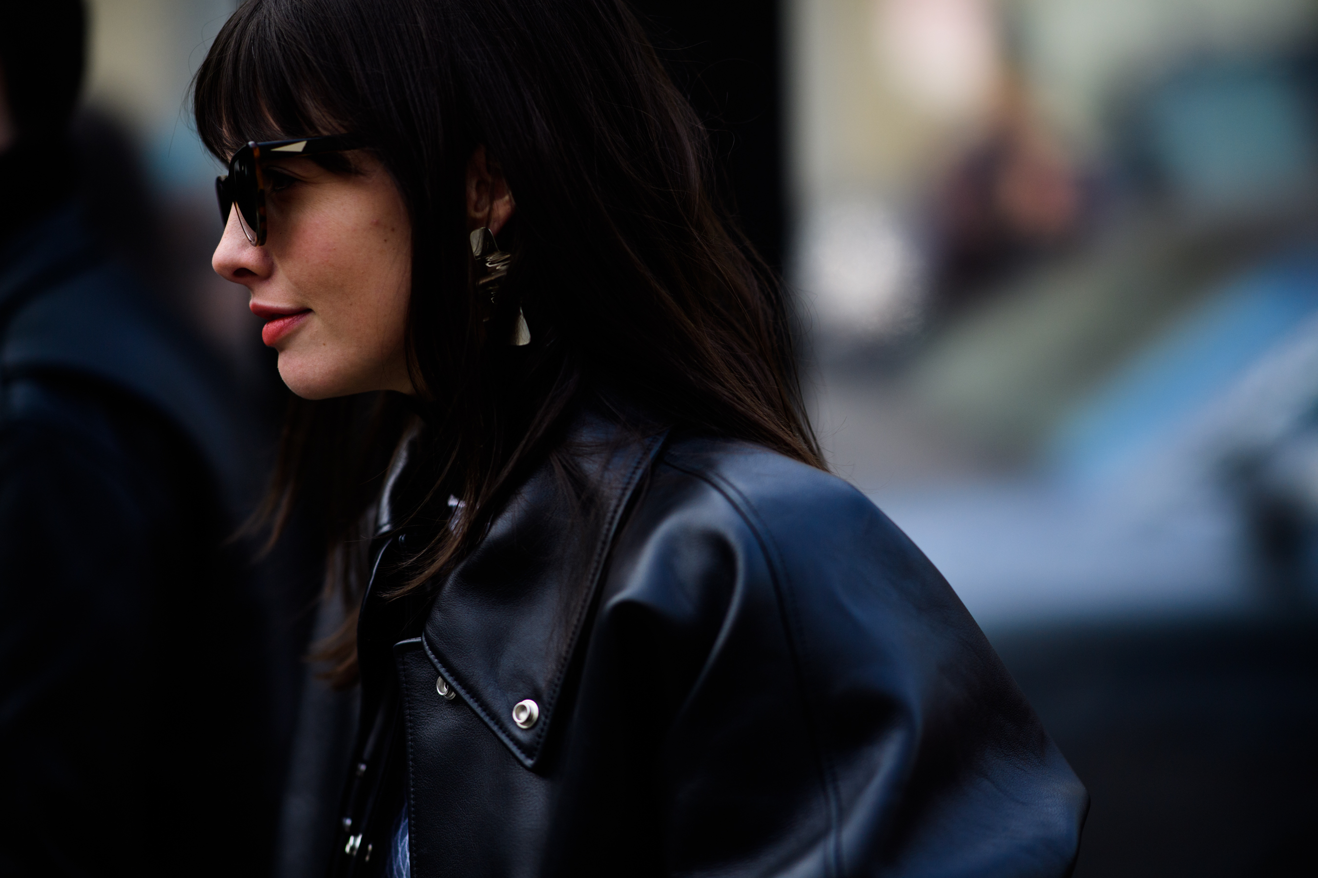 Woman wearing leather jacket and sunglasses