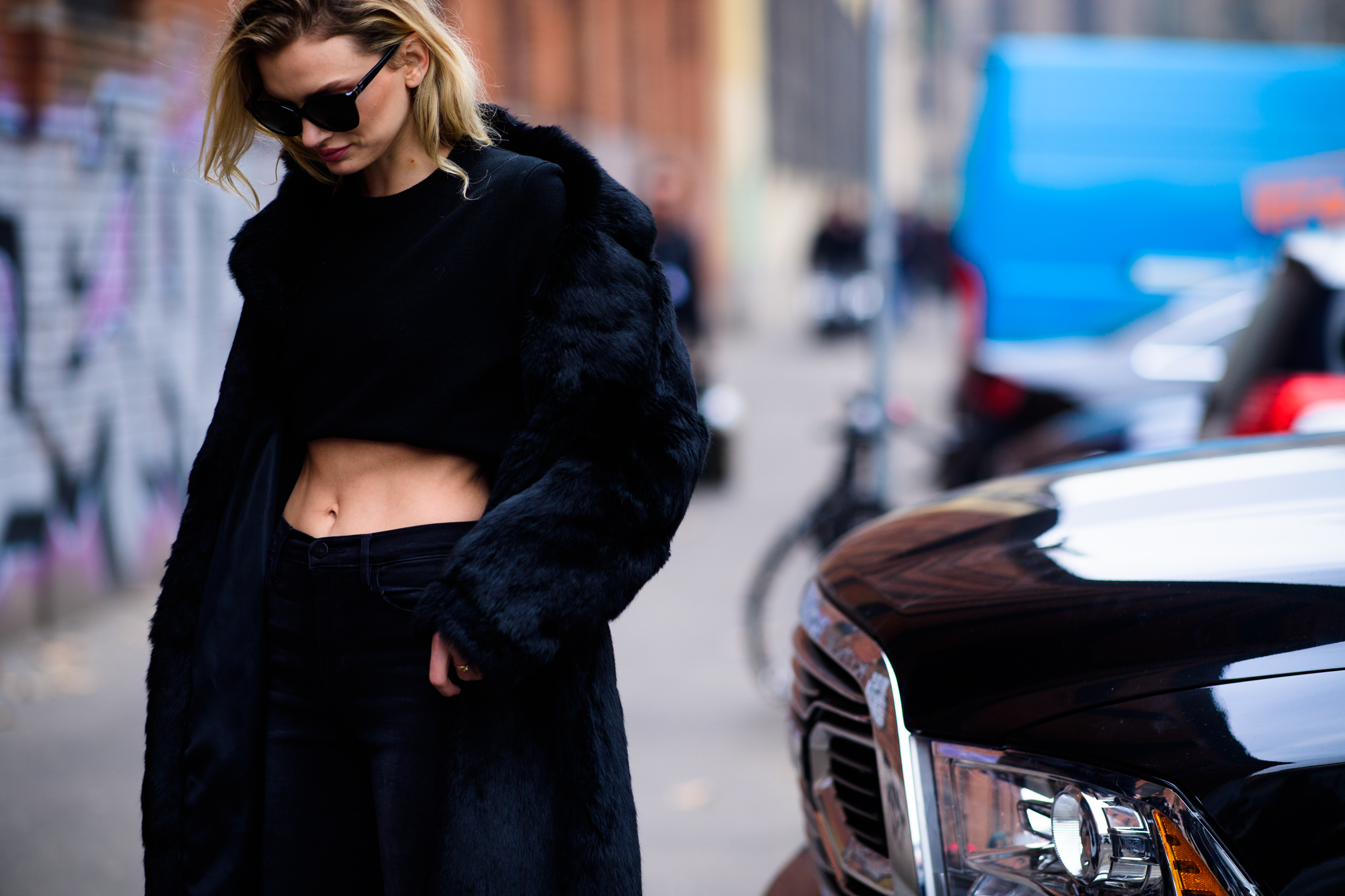 Model wearing fur coat and sunglasses