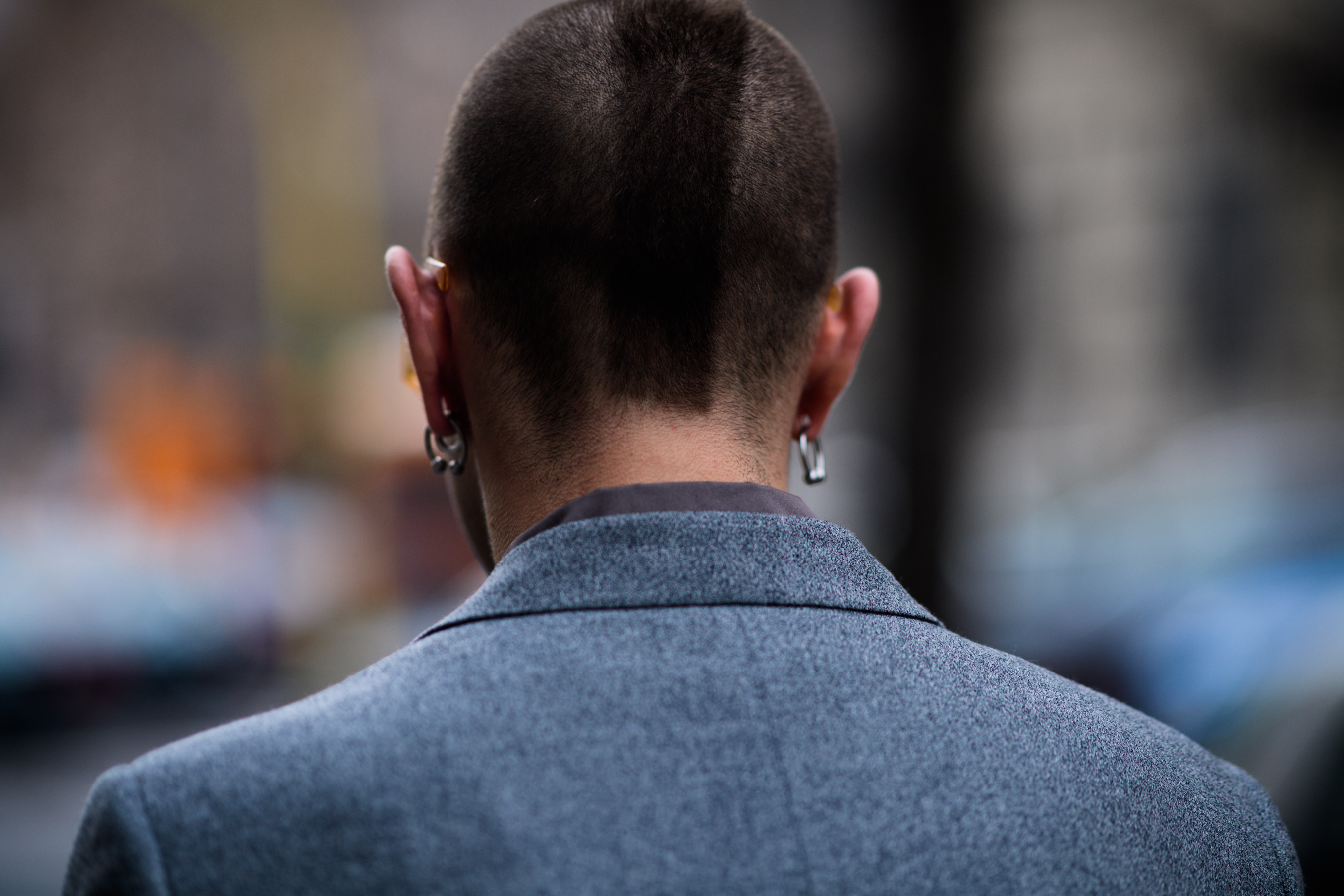 032C fashion editor wearing grey suit