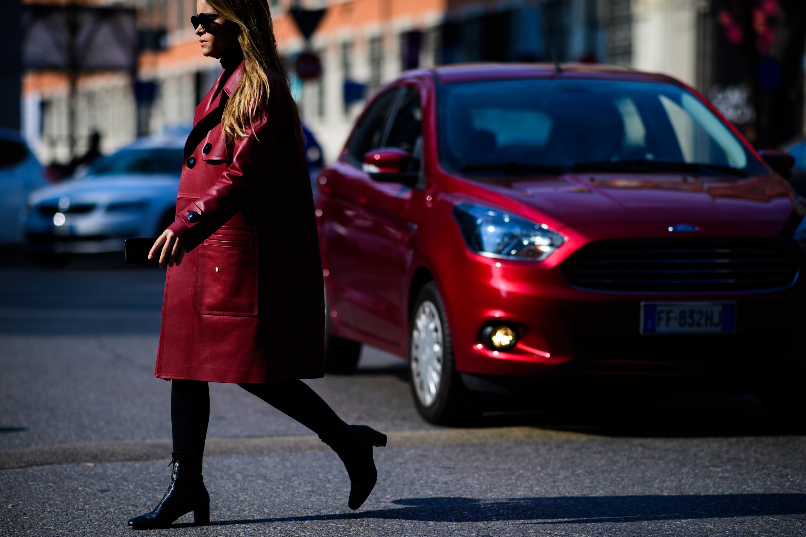 Woman wearing red Bally coat