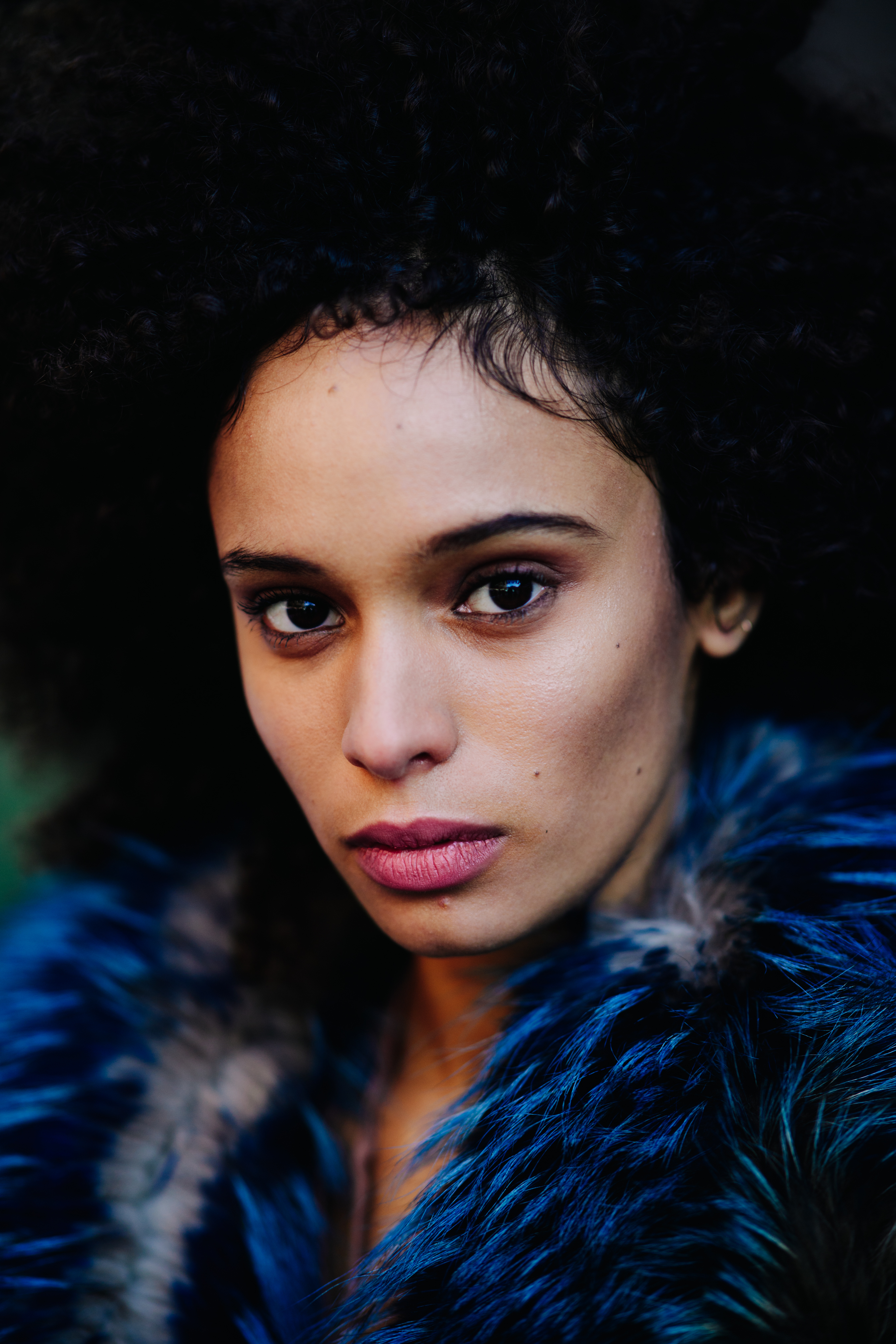 Portrait of woman with afro hair and fur clothes
