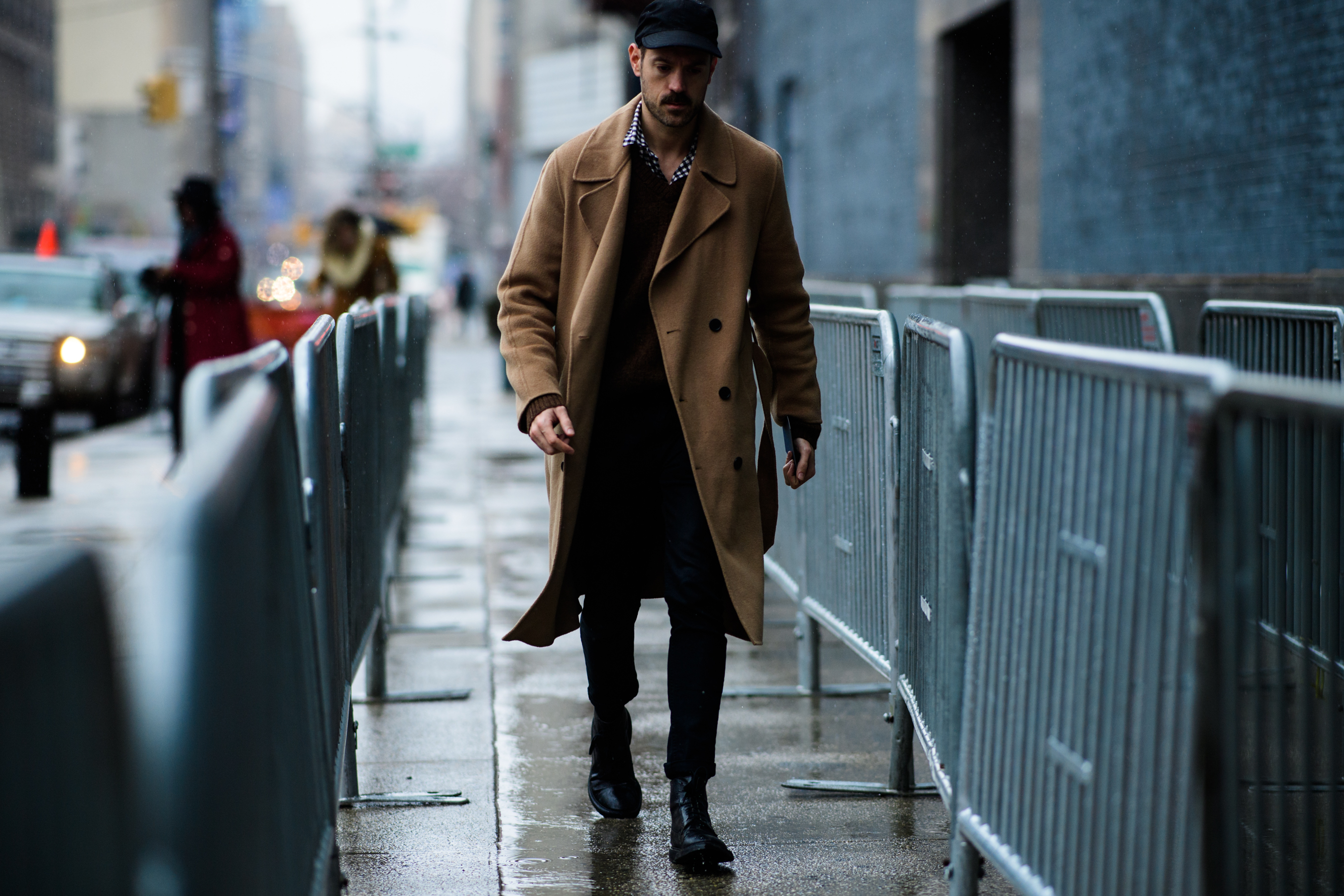 Man wearing brown coat and black cap