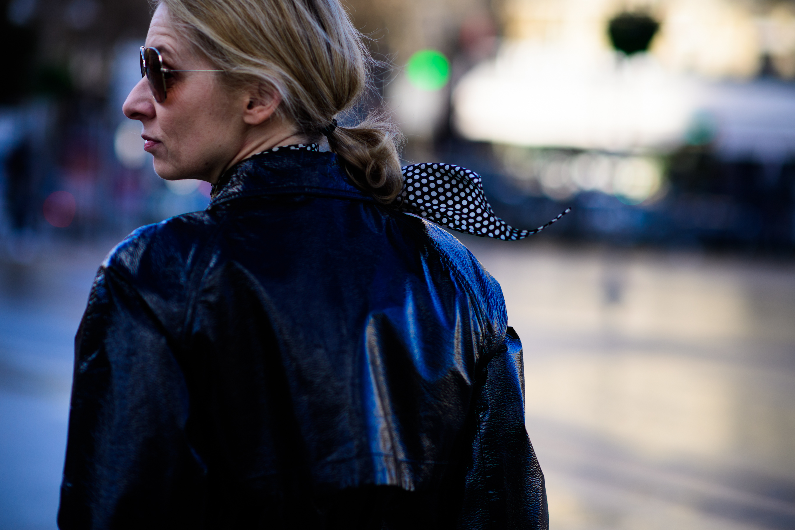 Woman wearing shiny leather coat