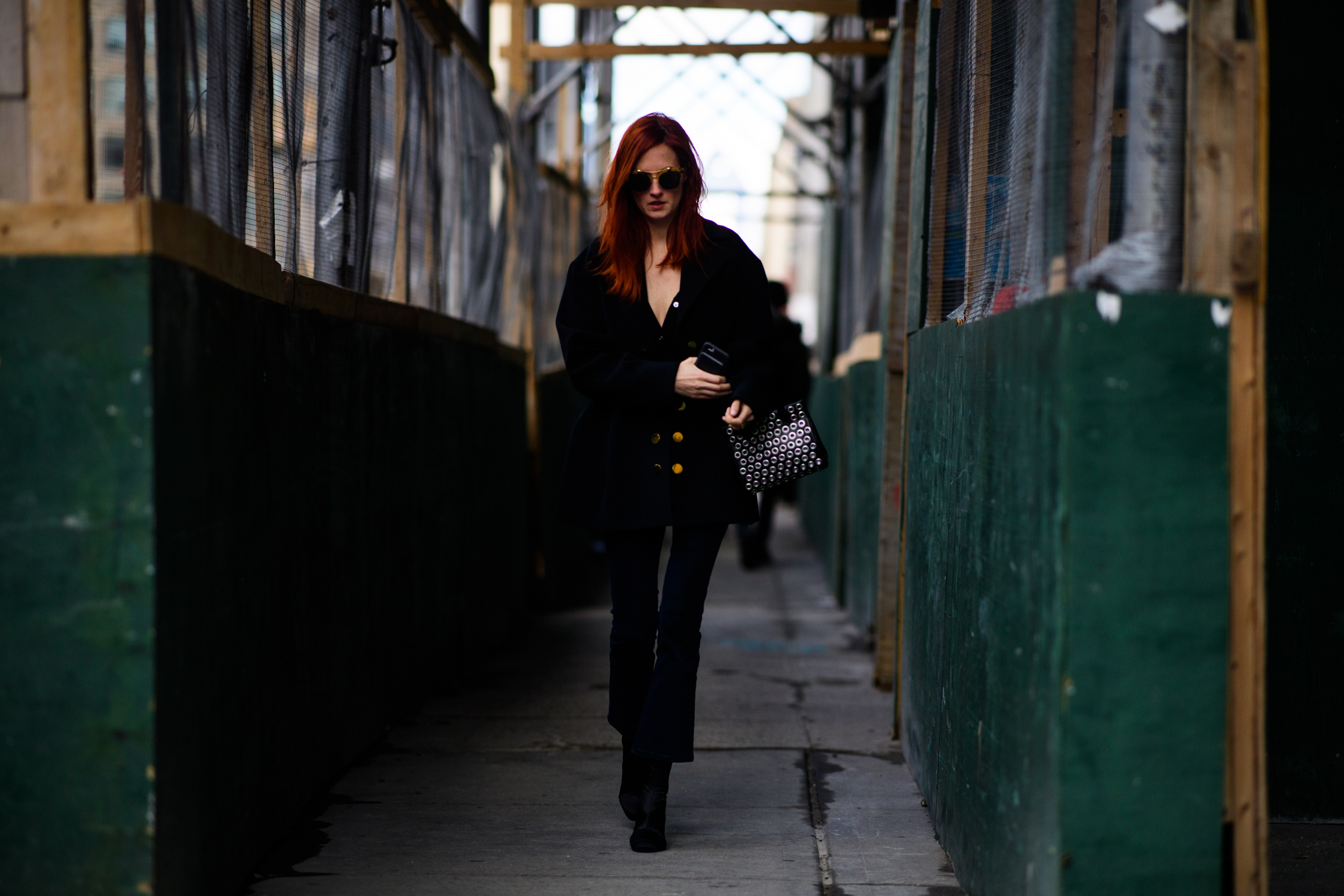 Editor with red hair wearing black