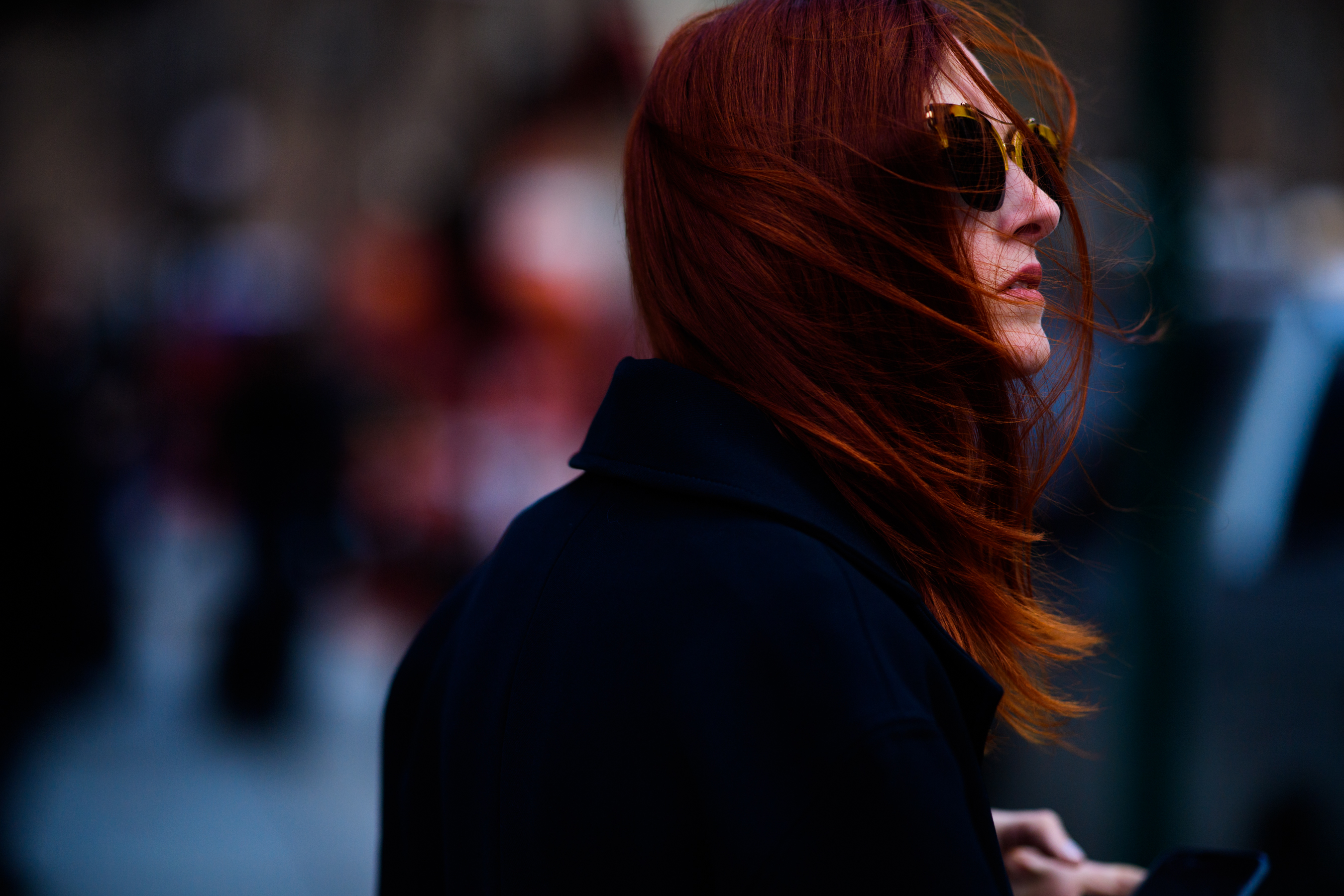 Editor with red hair wearing black