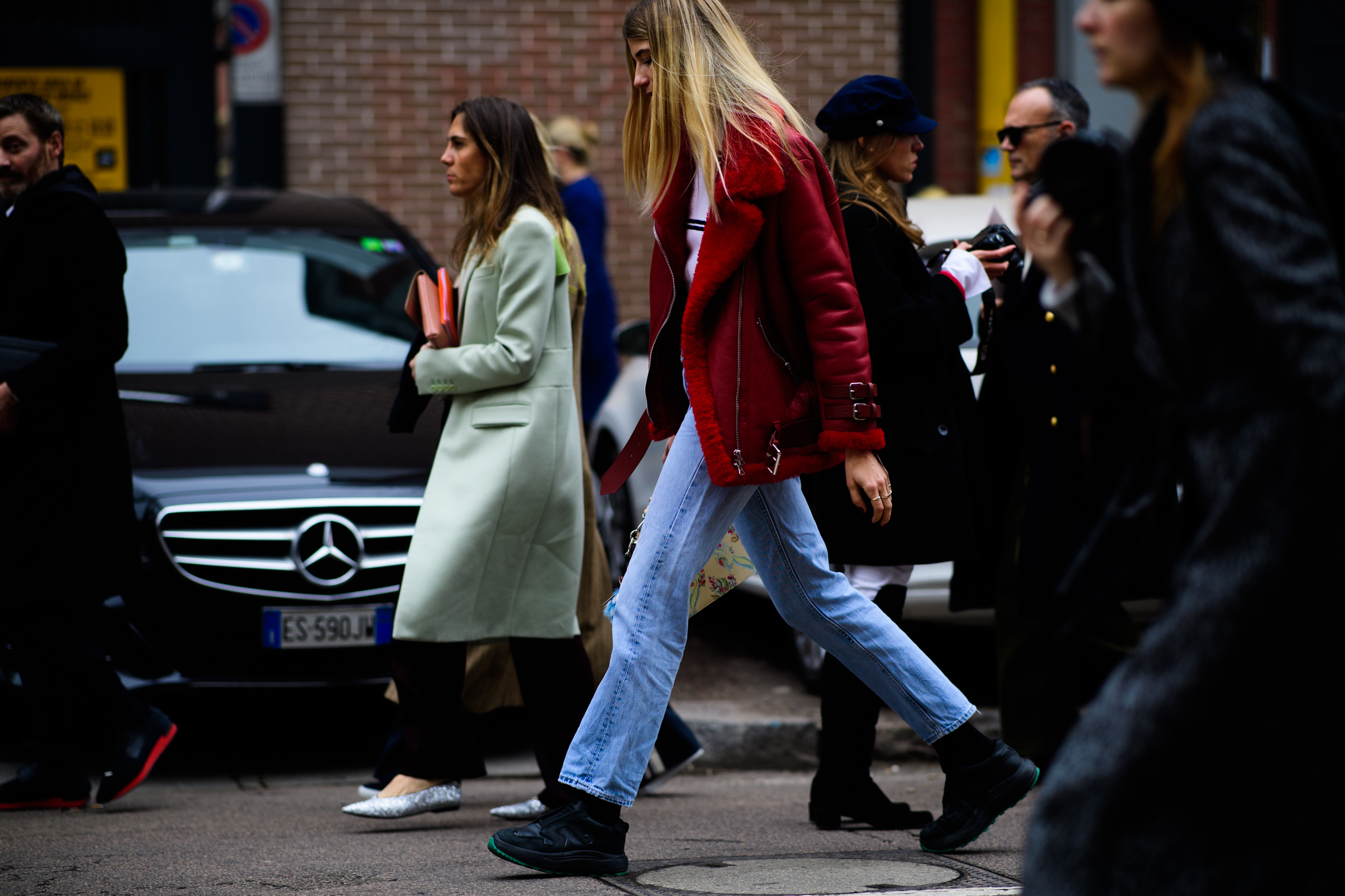Model wearing red jacket and denim