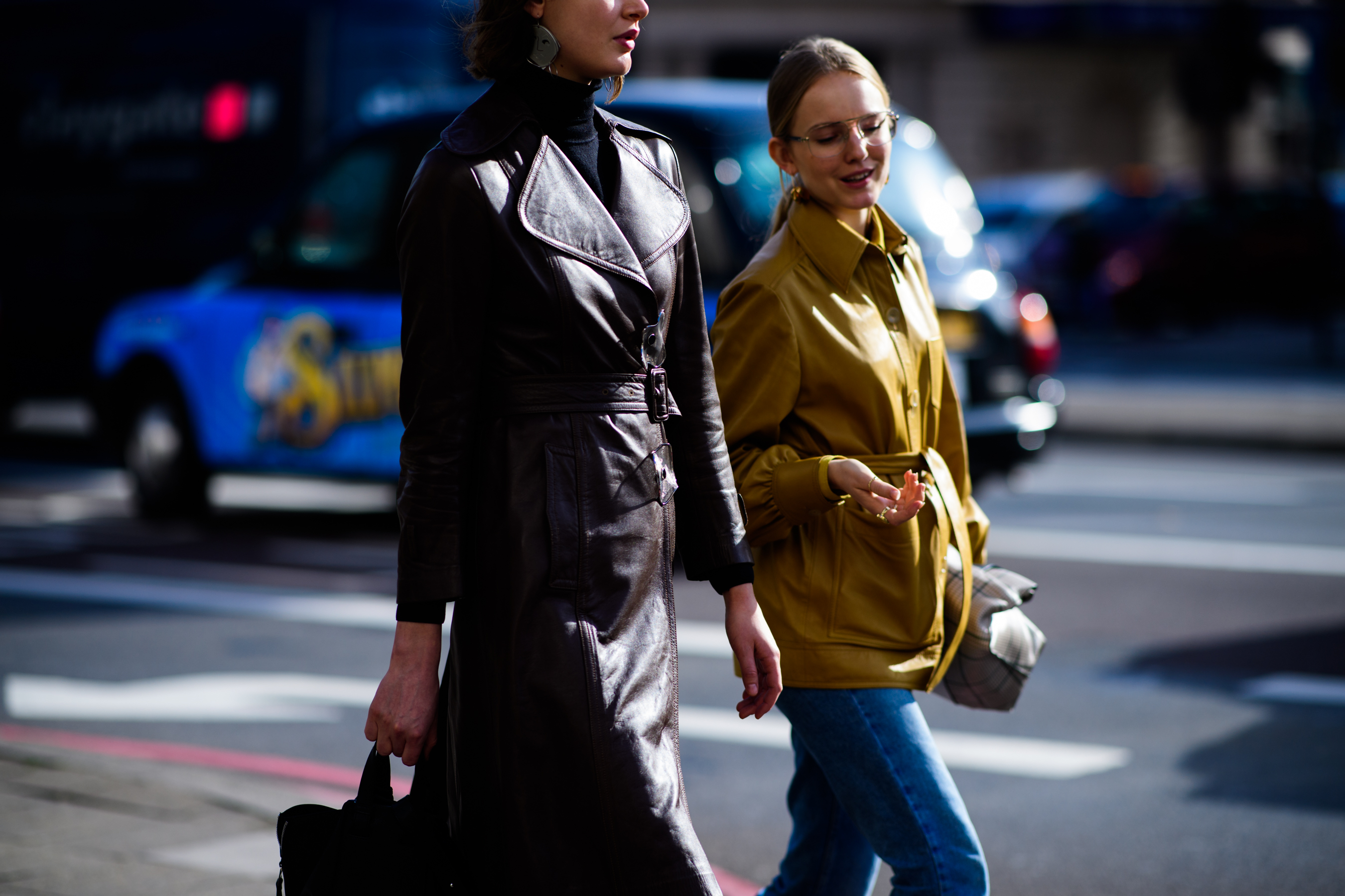 Two women wearing leather coats