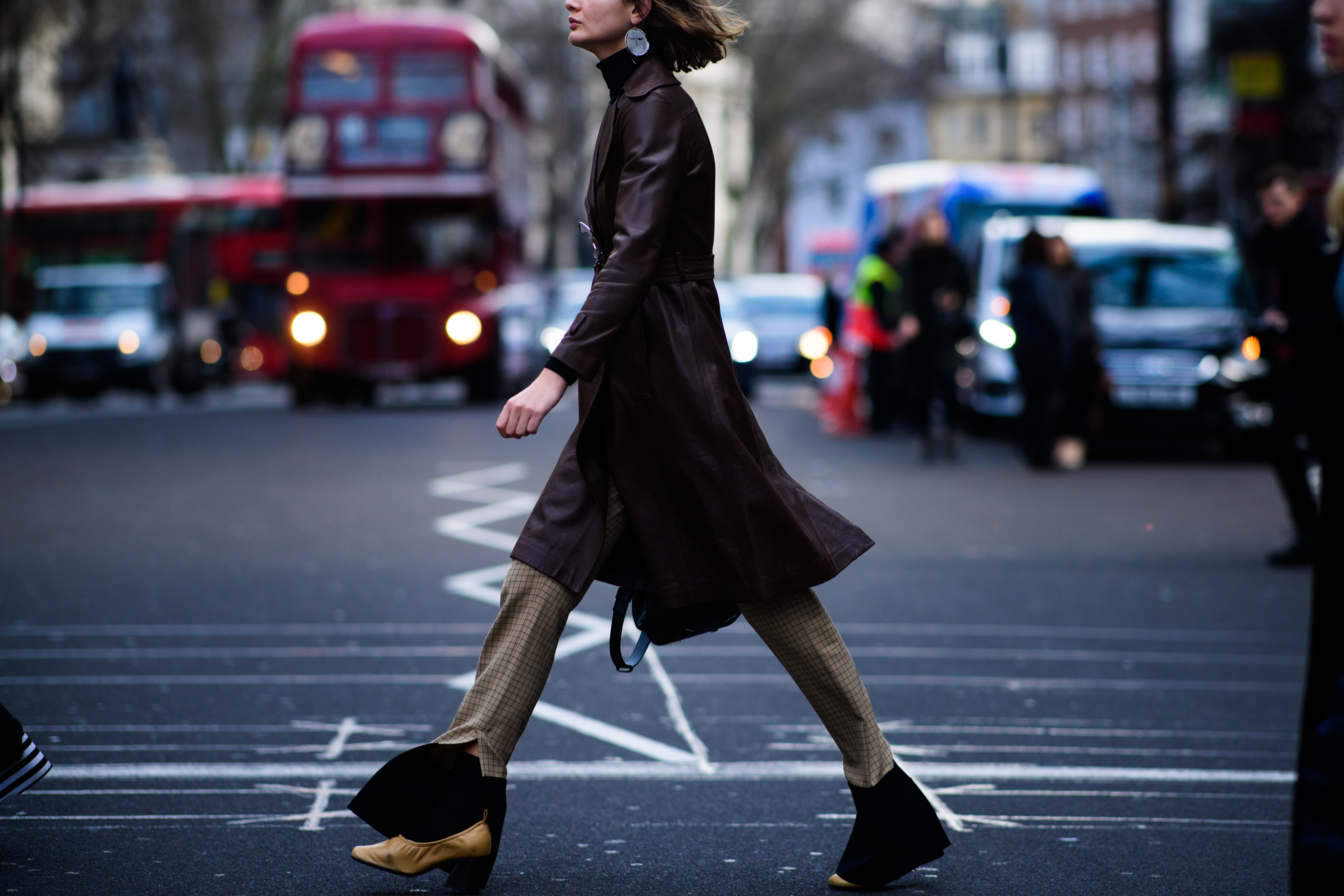 Woman wearing leather dress coat
