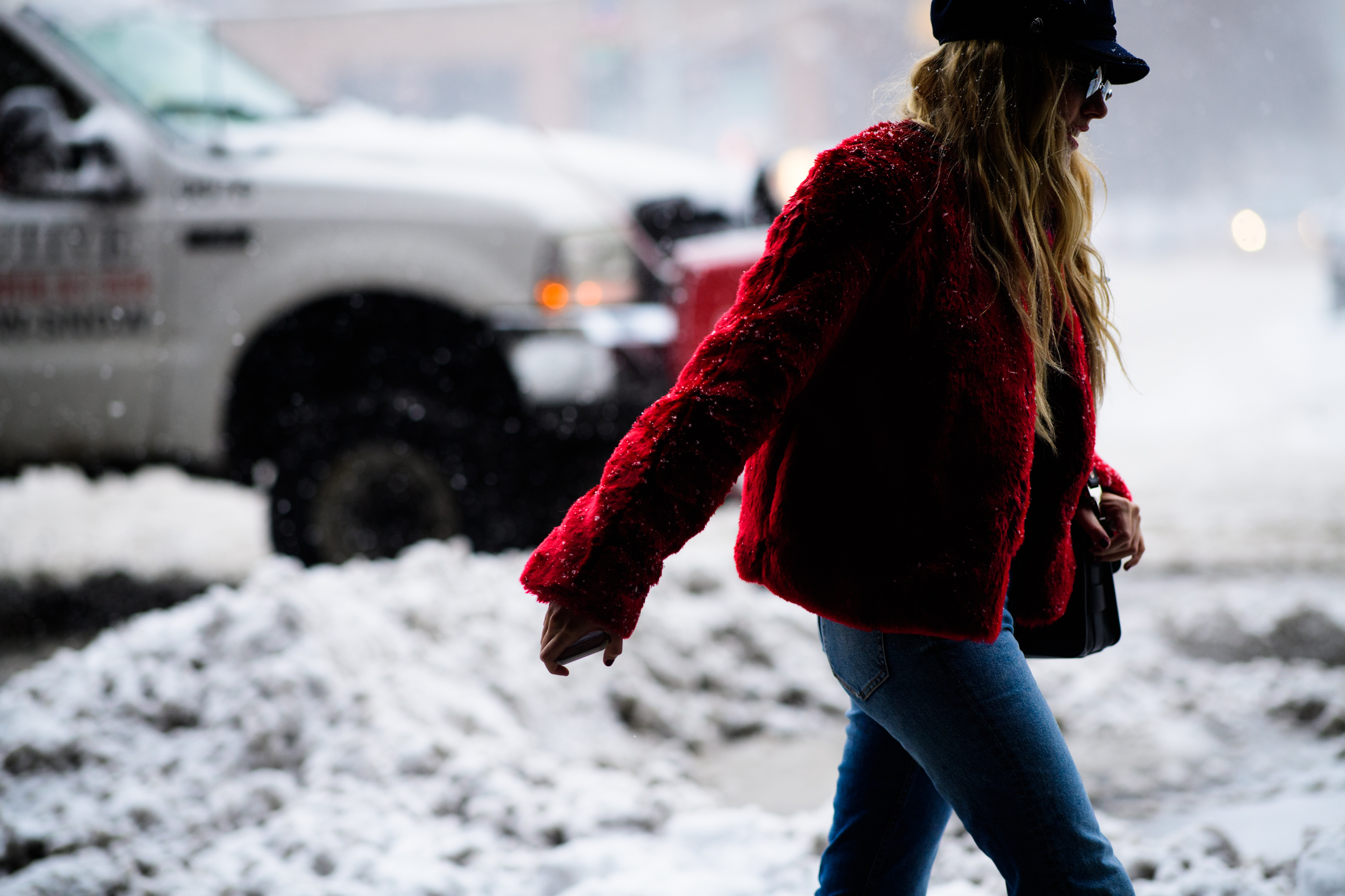 Woman wearing red jacket and blue jeans