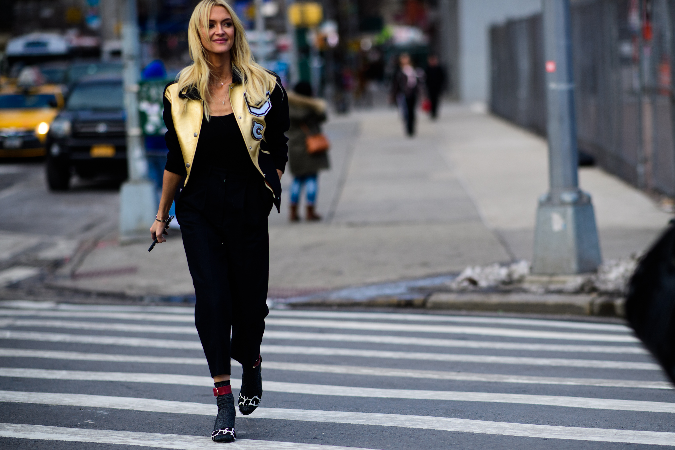 Woman wearing golden bomber