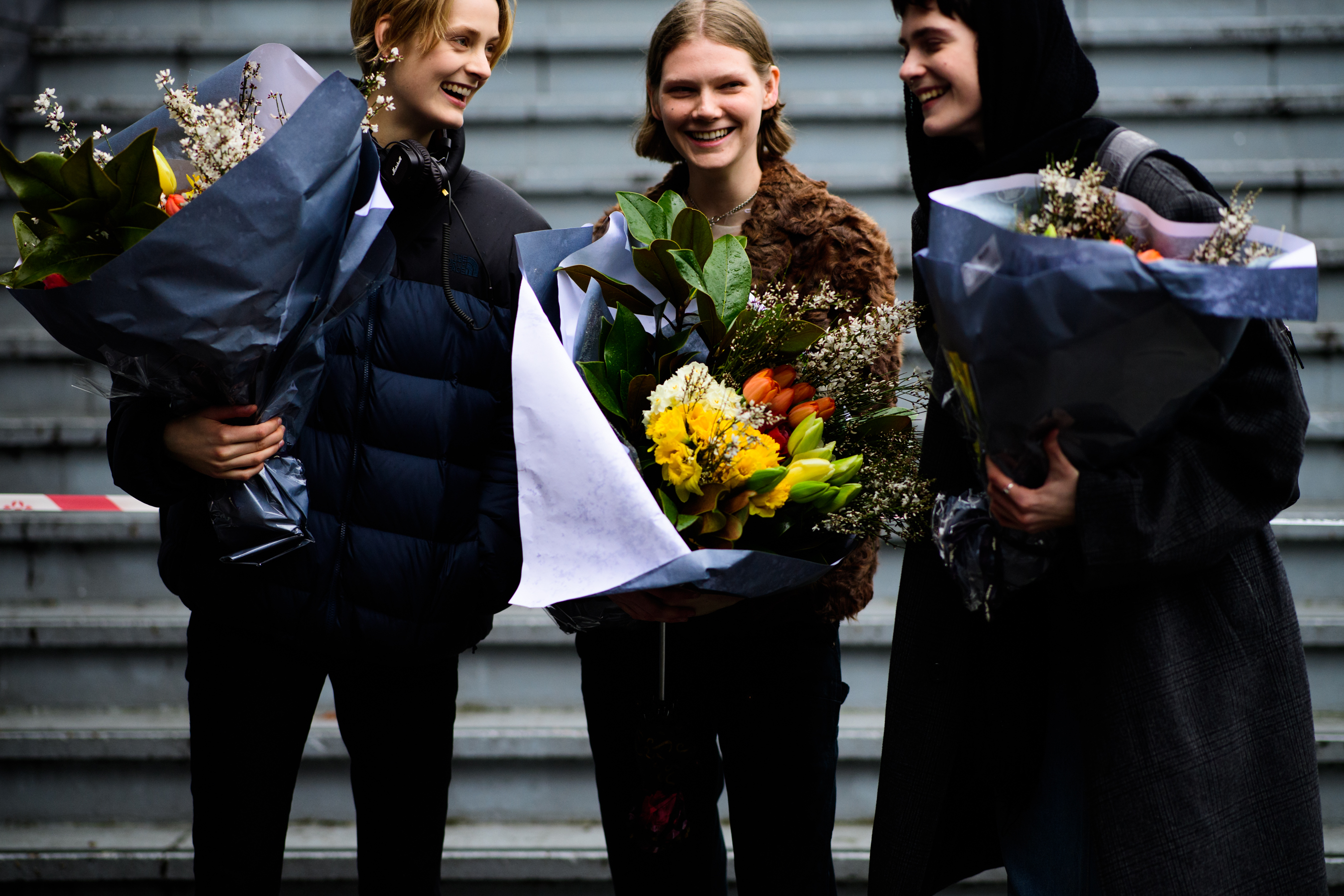 Three models with flowers boquetes