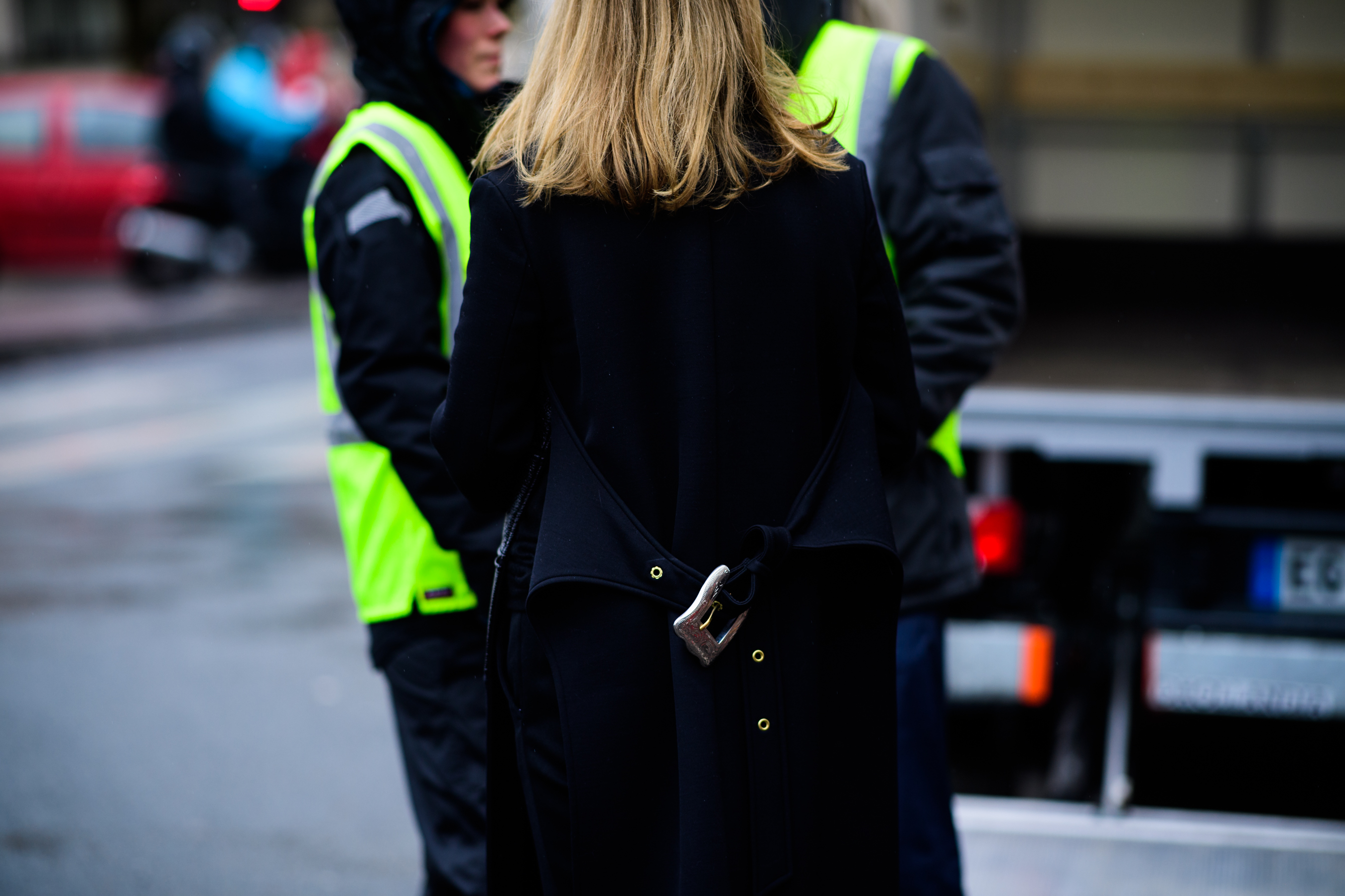 Woman wearing coat with the belt