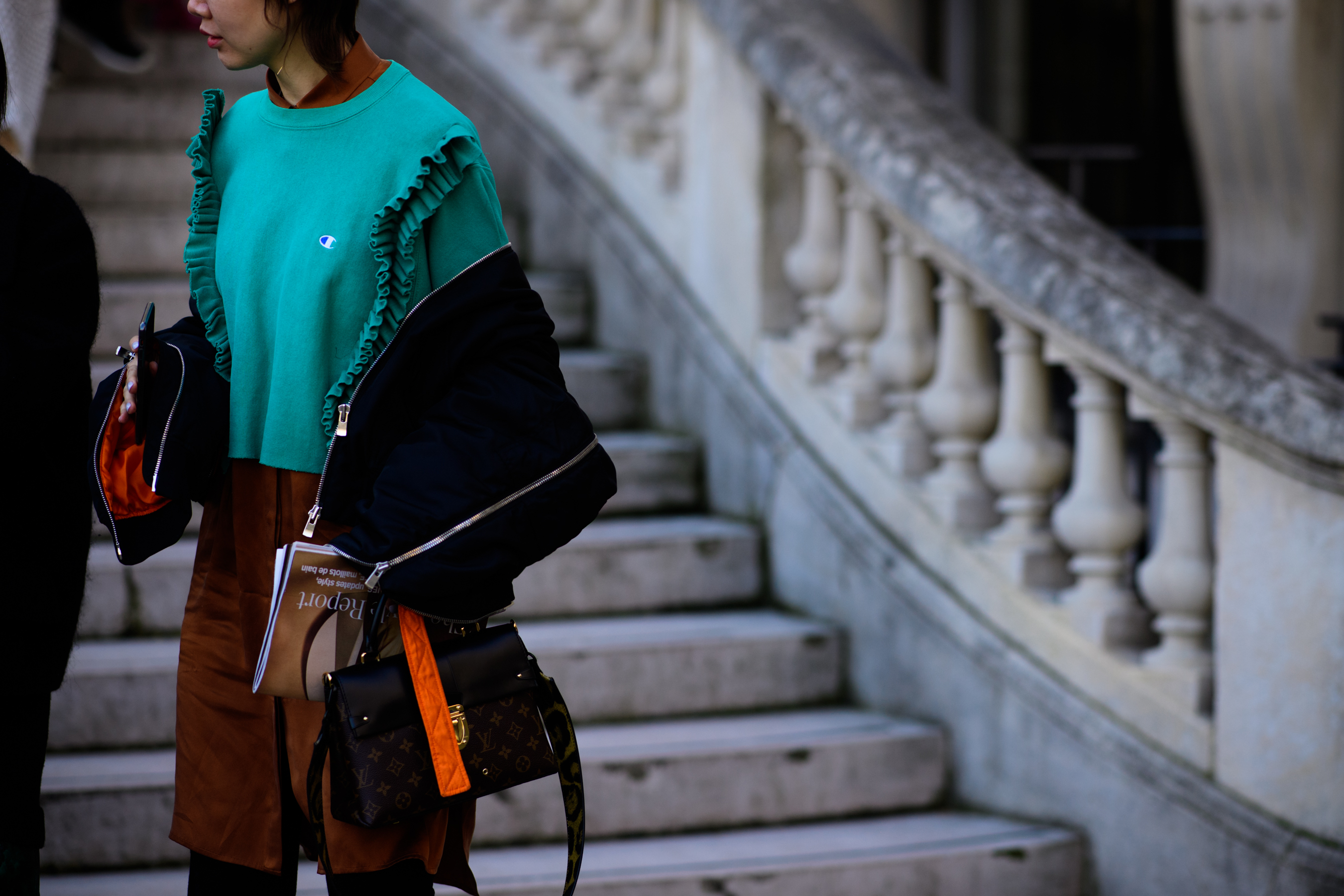 Woman wearing green Champion sweater