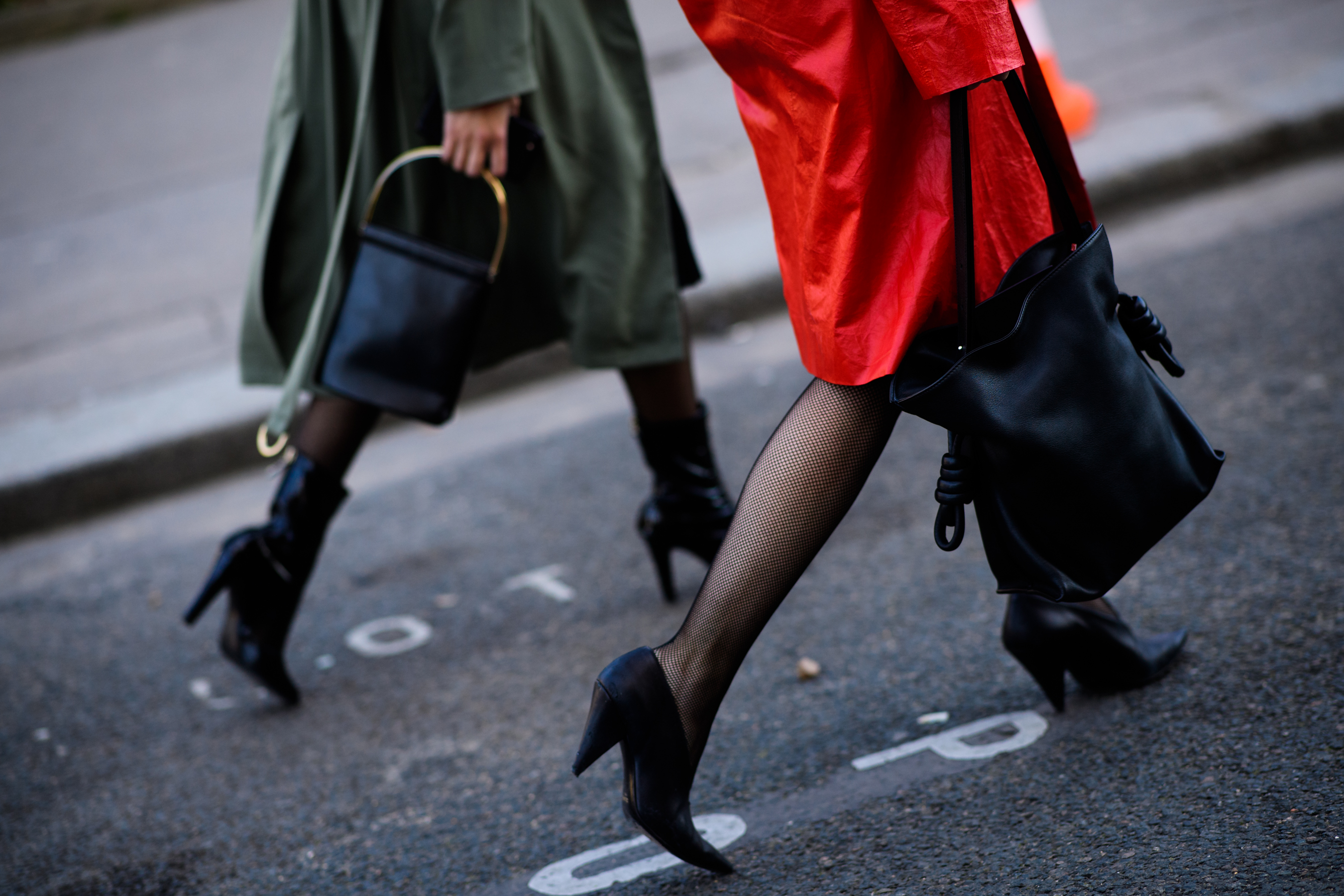 Two women with black handbags