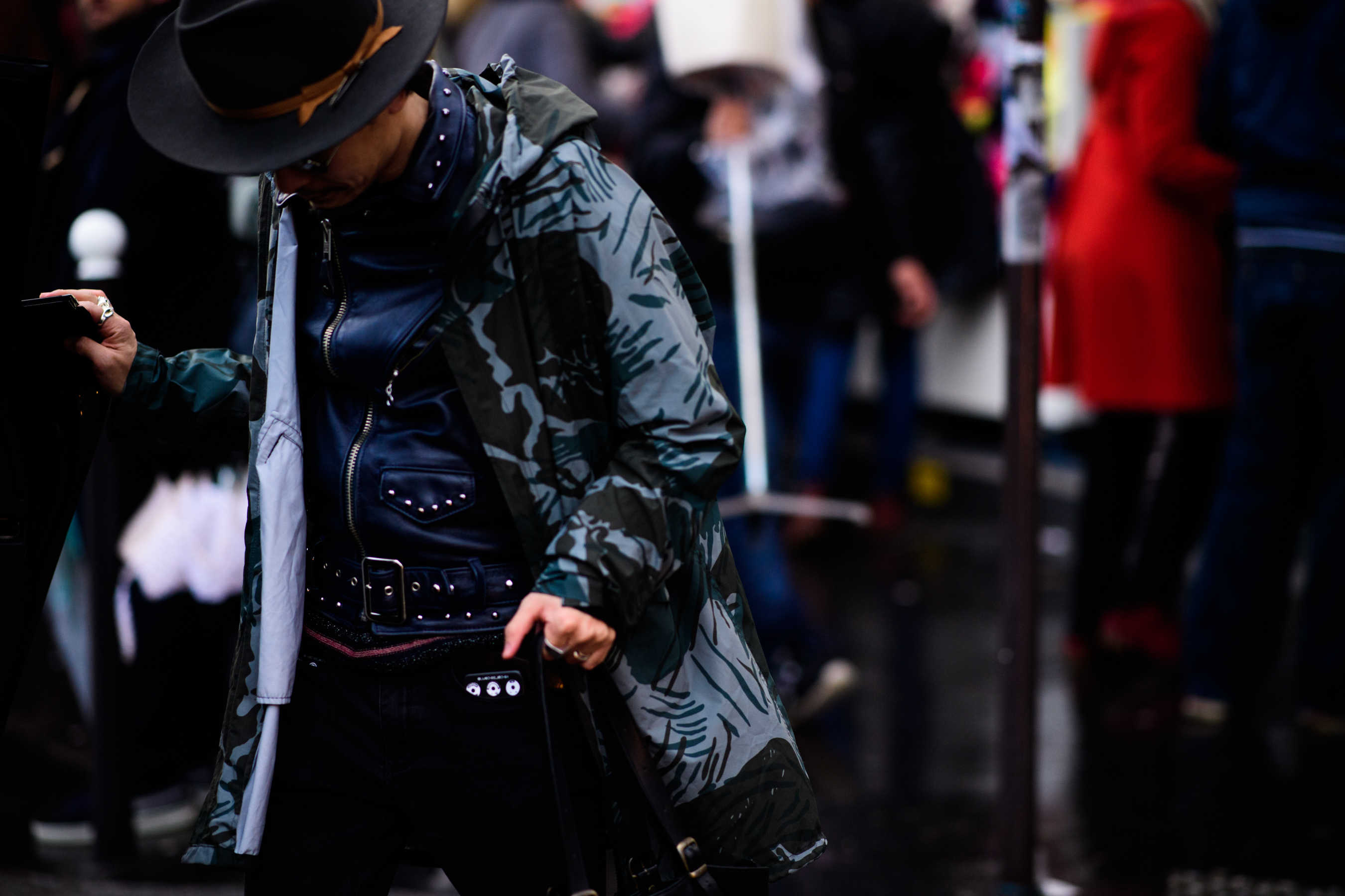 Man wearing raincoat over leather jacket