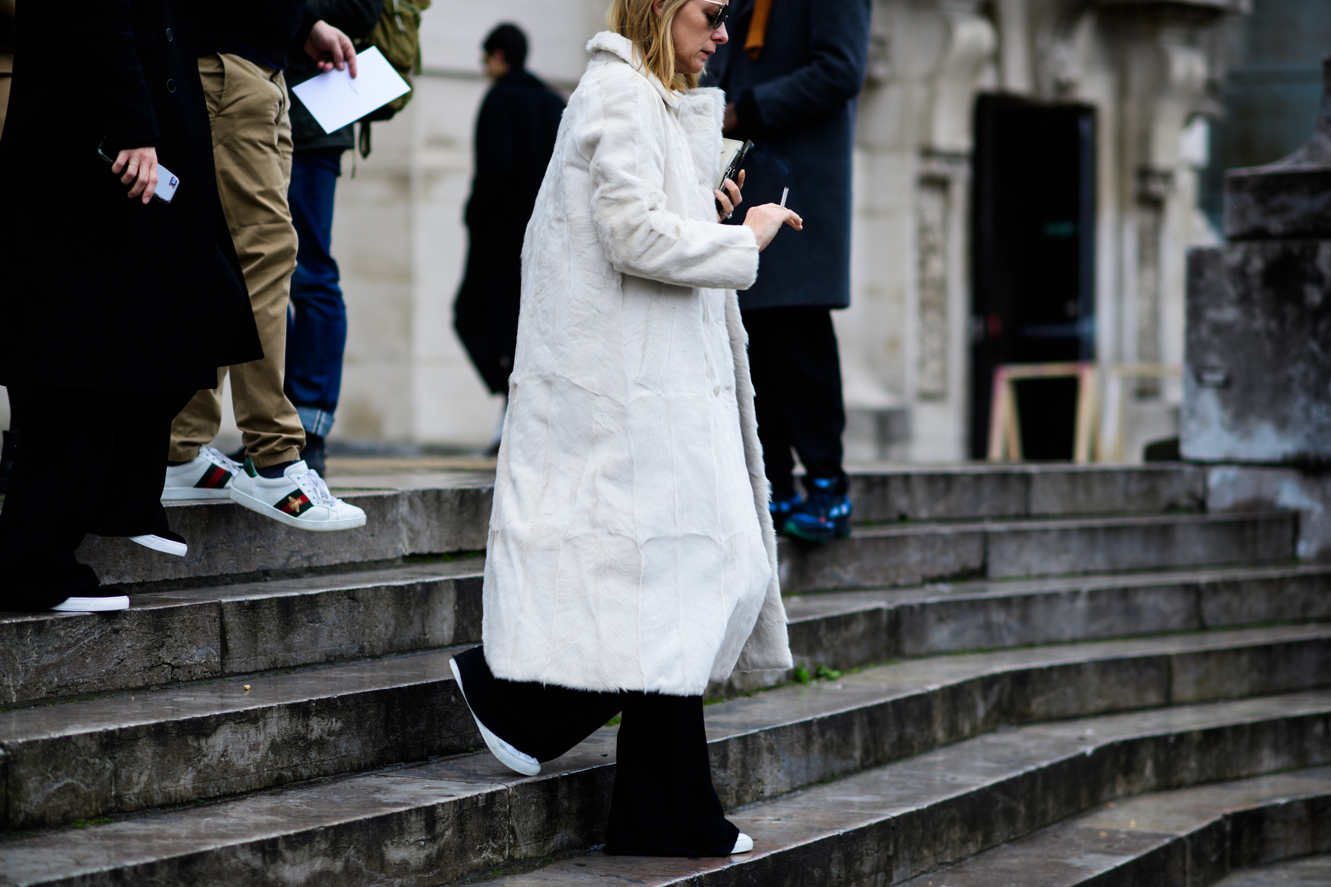 Woman wearing white fur coat