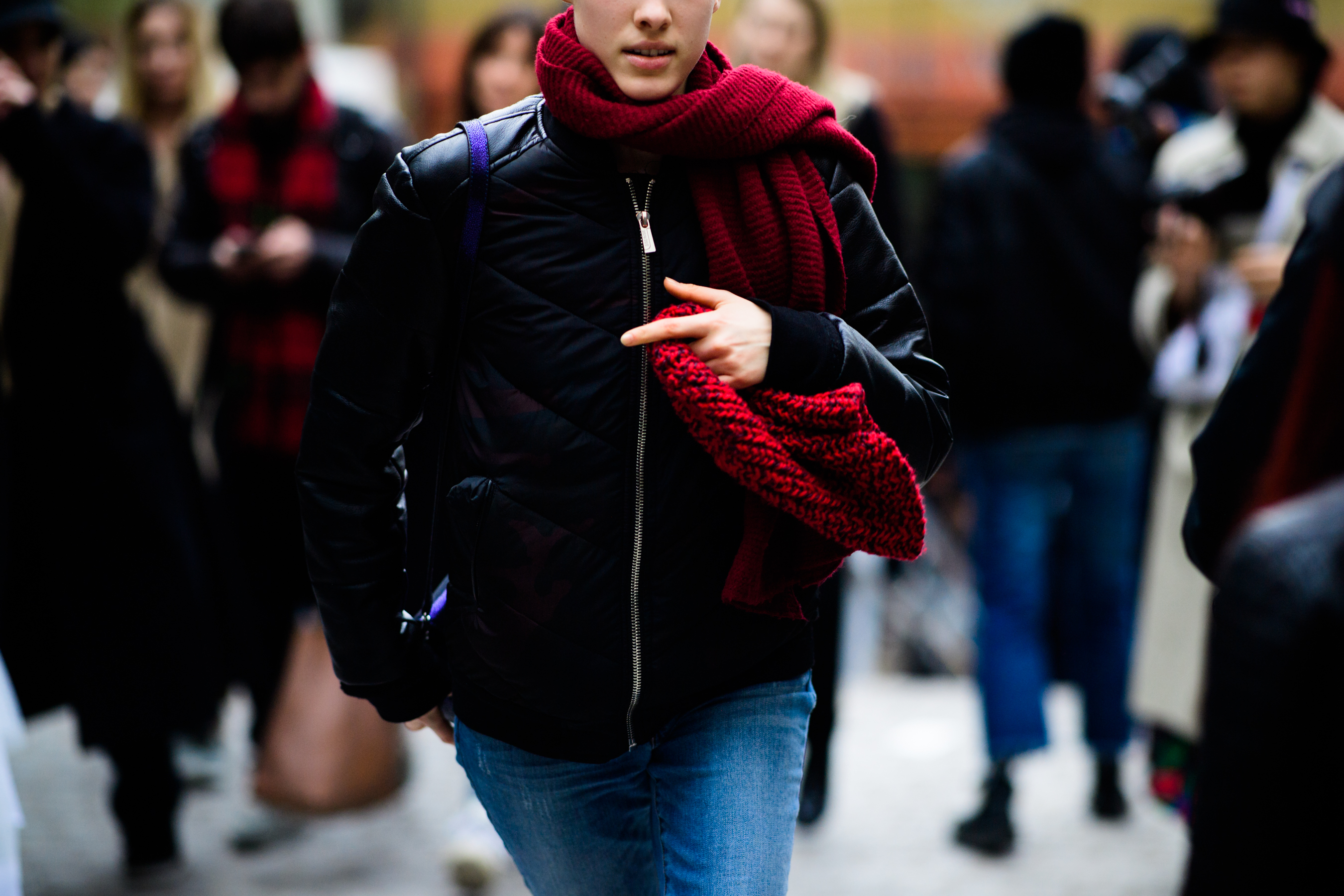 Woman wearing red scarf and bomber