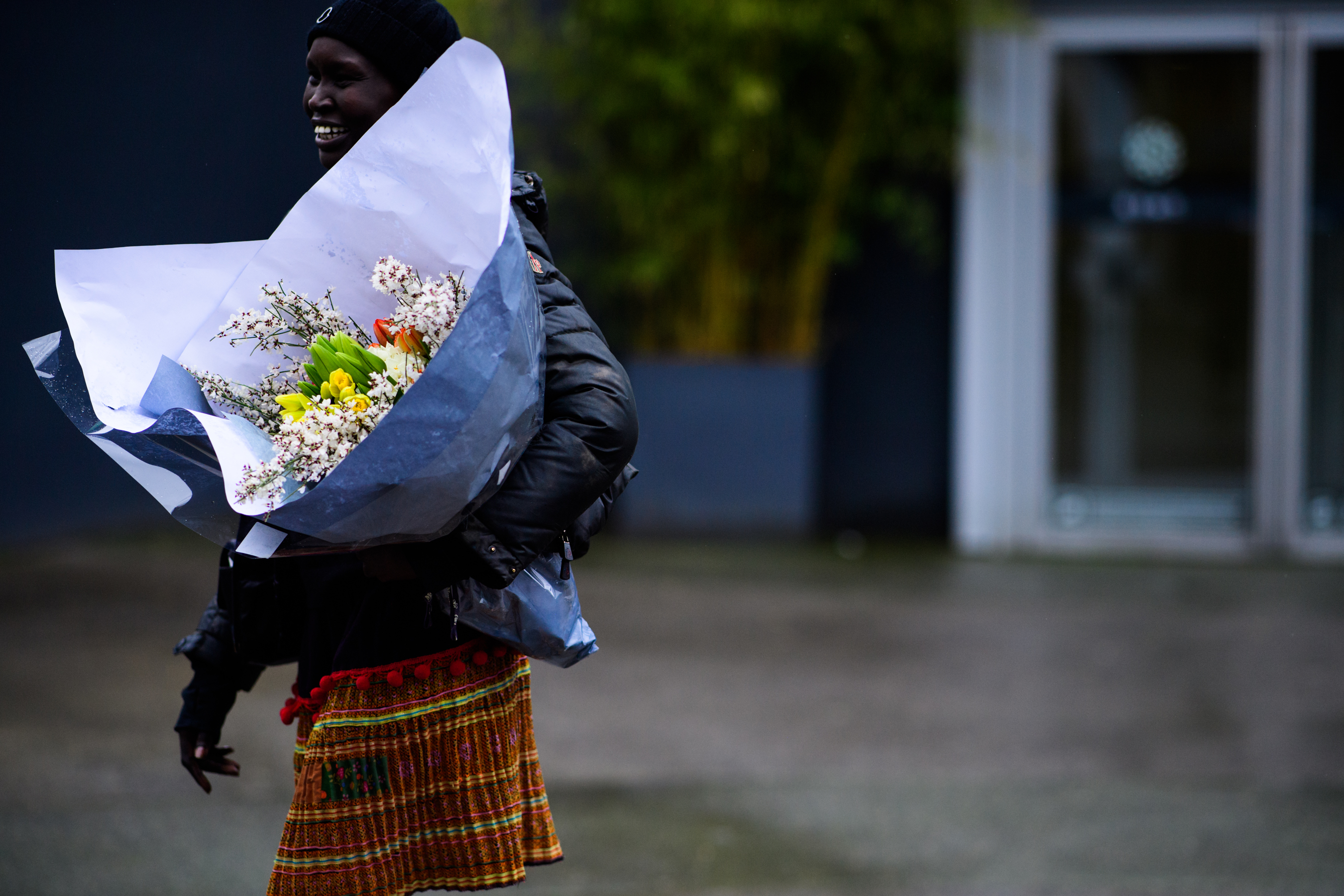 Model carrying flowers after Balenciaga