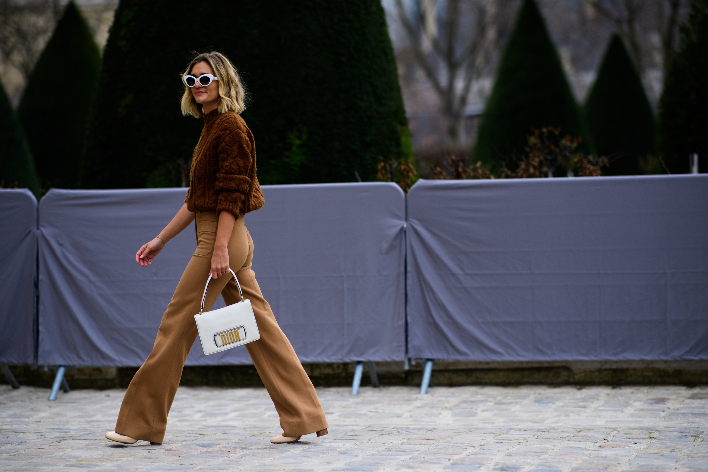 Woman wearing beige outfit and Dior bag