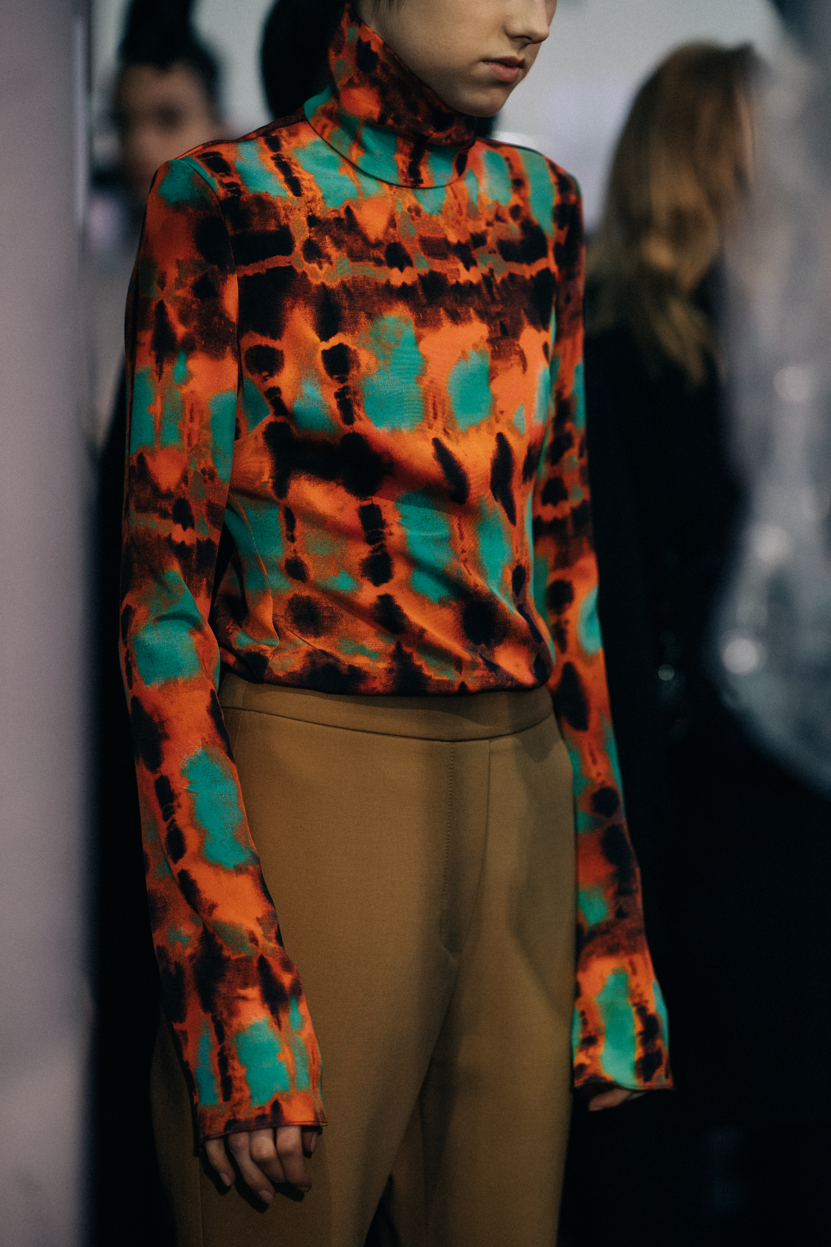 Model Jay Jankowska wearing orange blouse