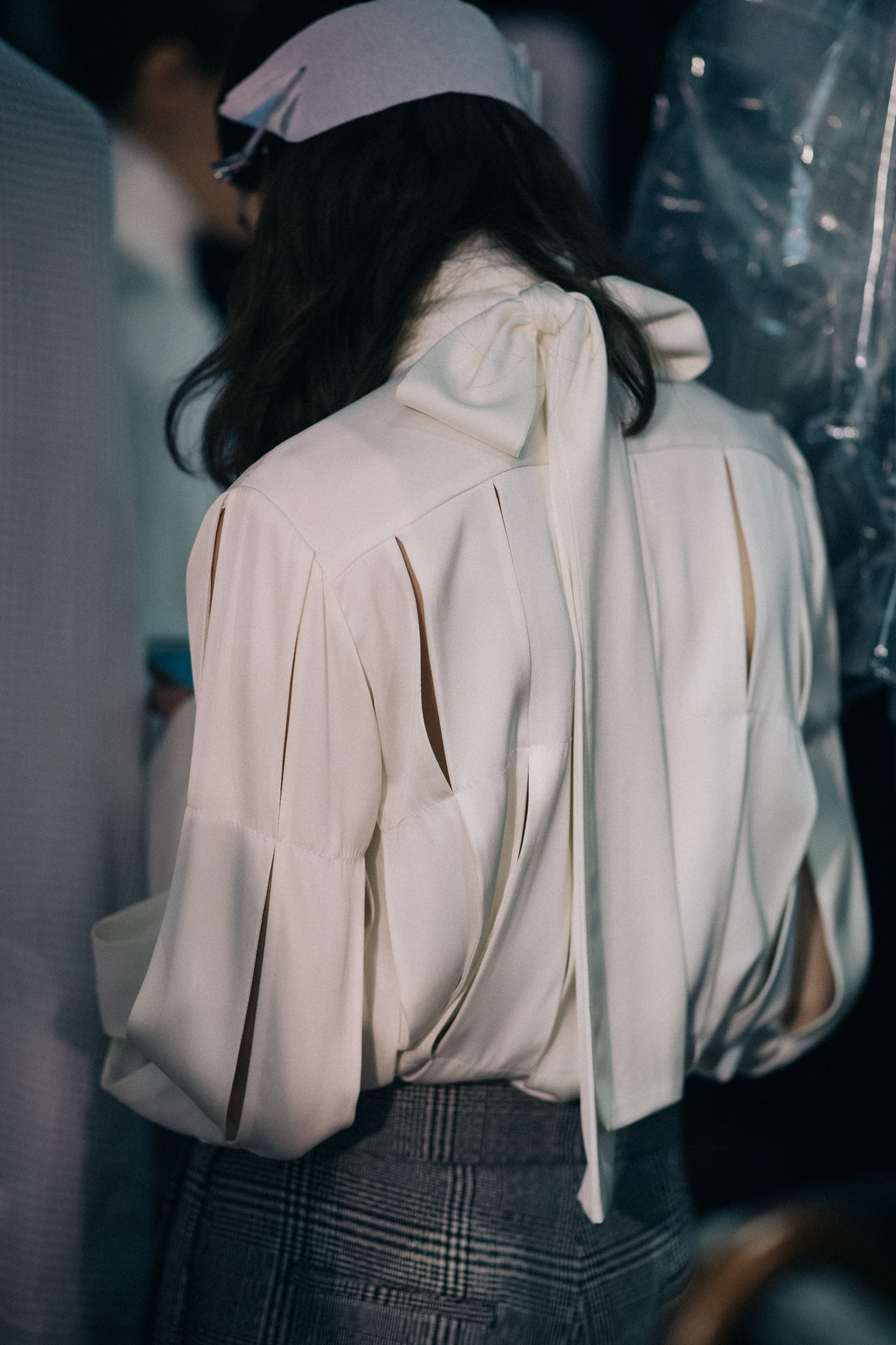 Model Lea Issarni wearing white blouse
