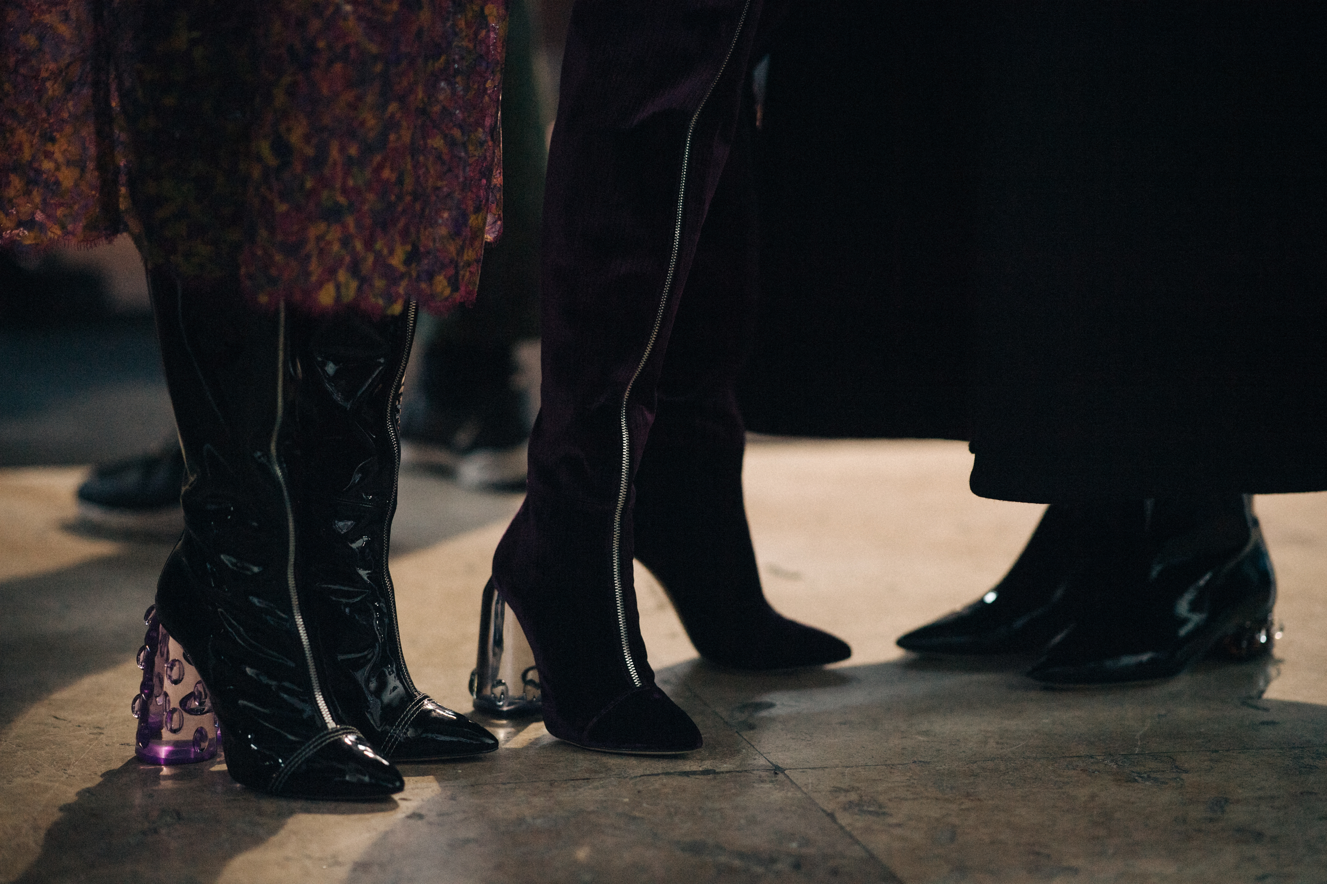 Models wearing shoes with transparent heels