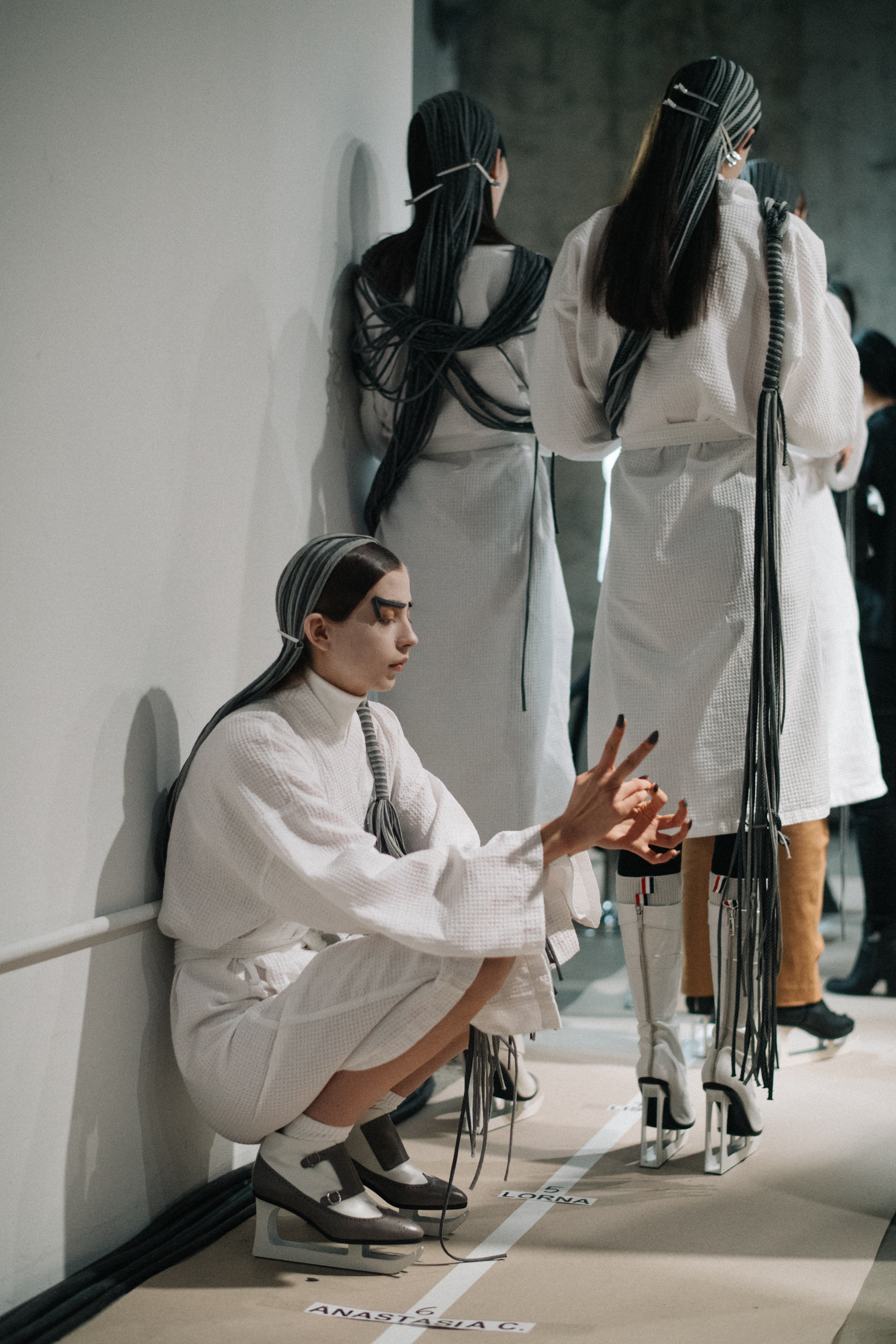 Models wearing white before the show