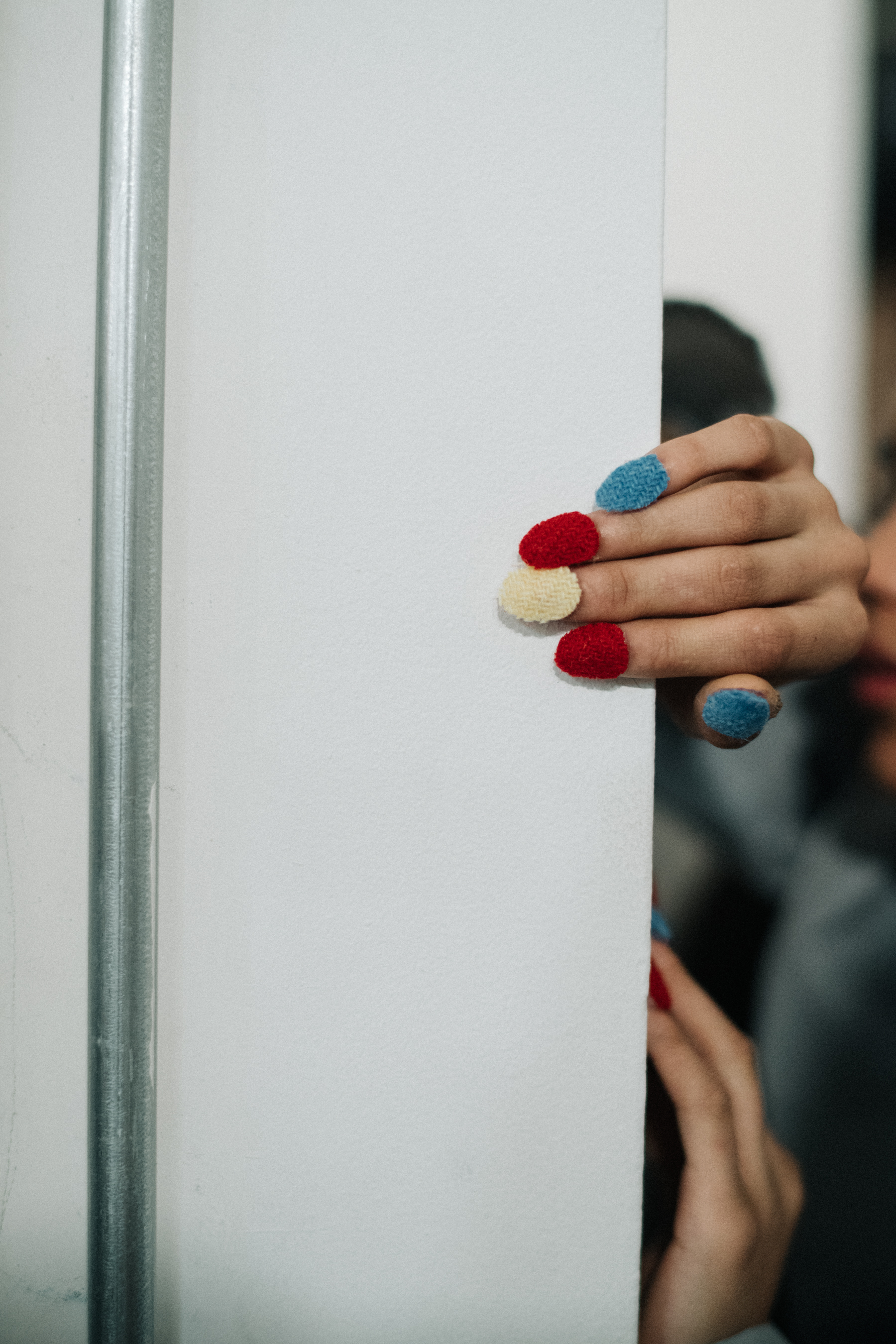 Model with three different colors of nails