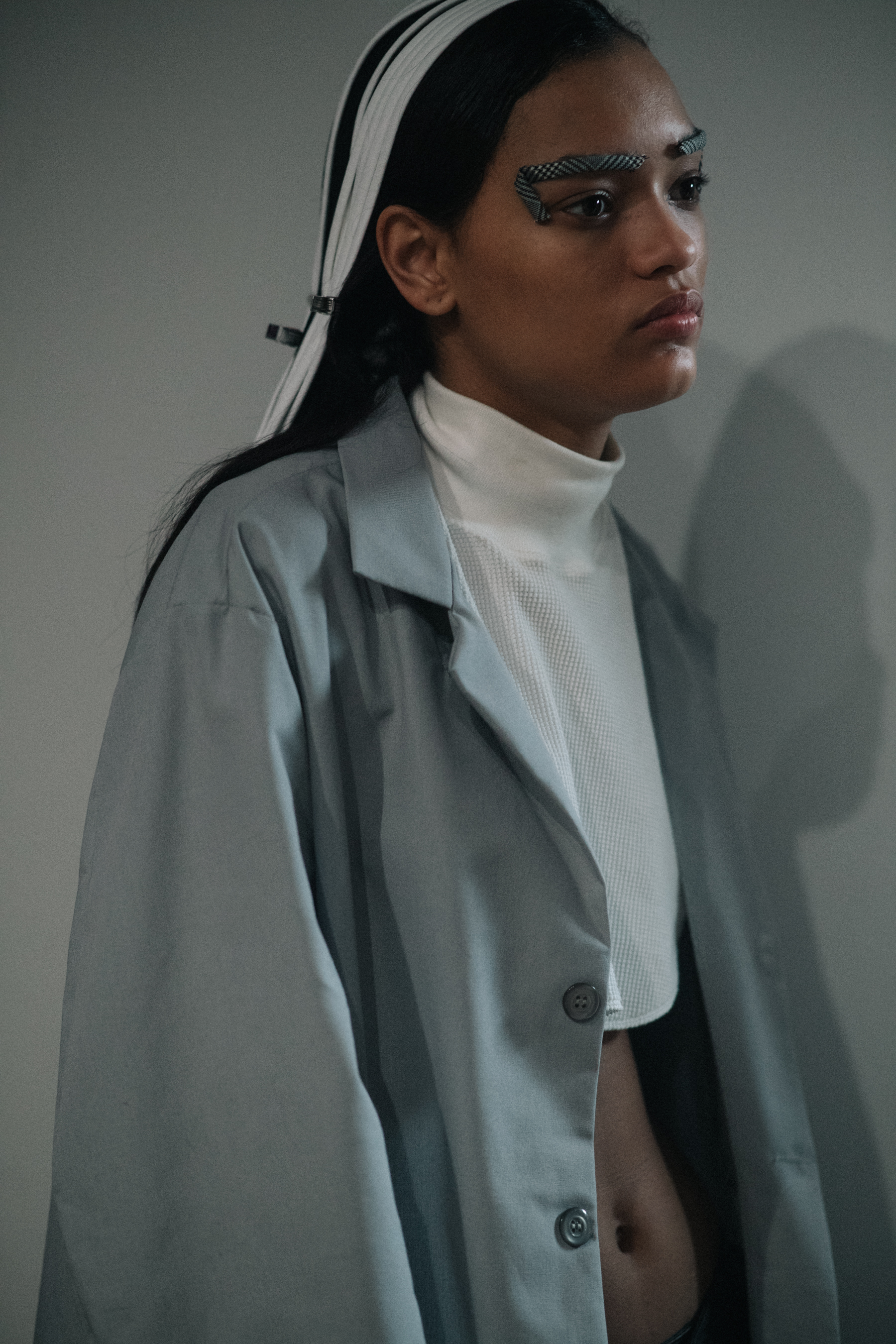 Model wearing grey coat