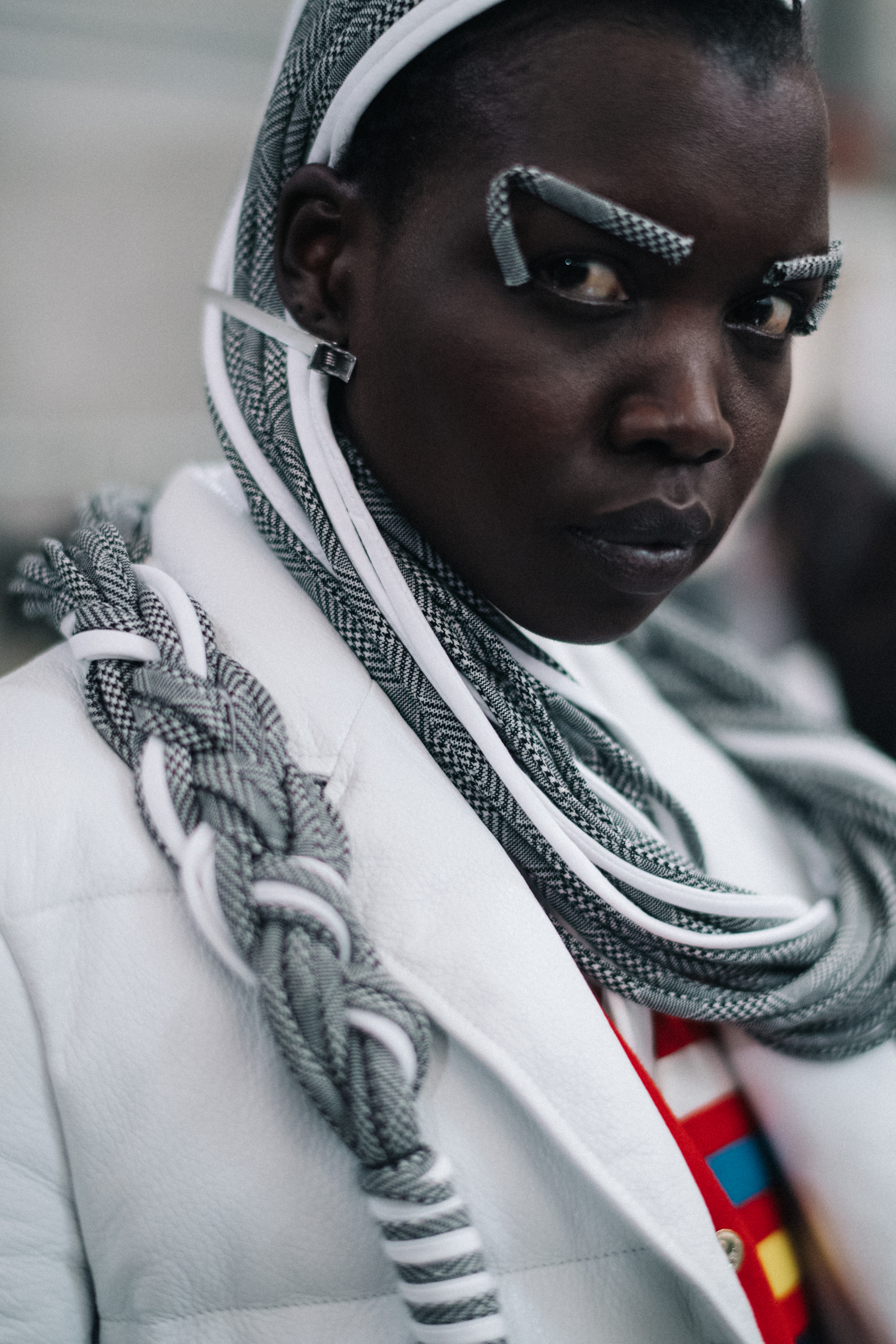 Nykhor Paul wearing white jacket
