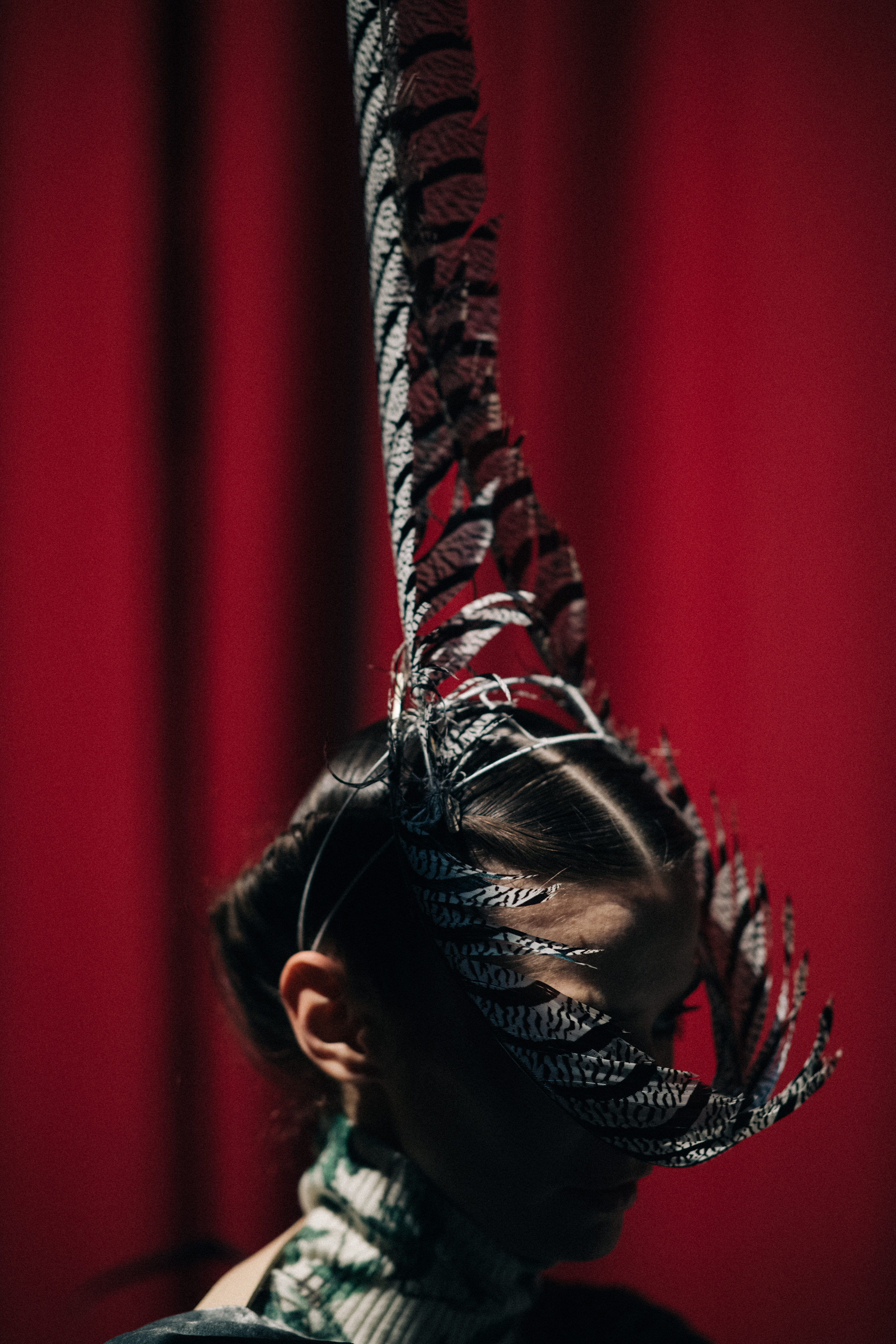 Model Dasha Denisenko wearing feathers