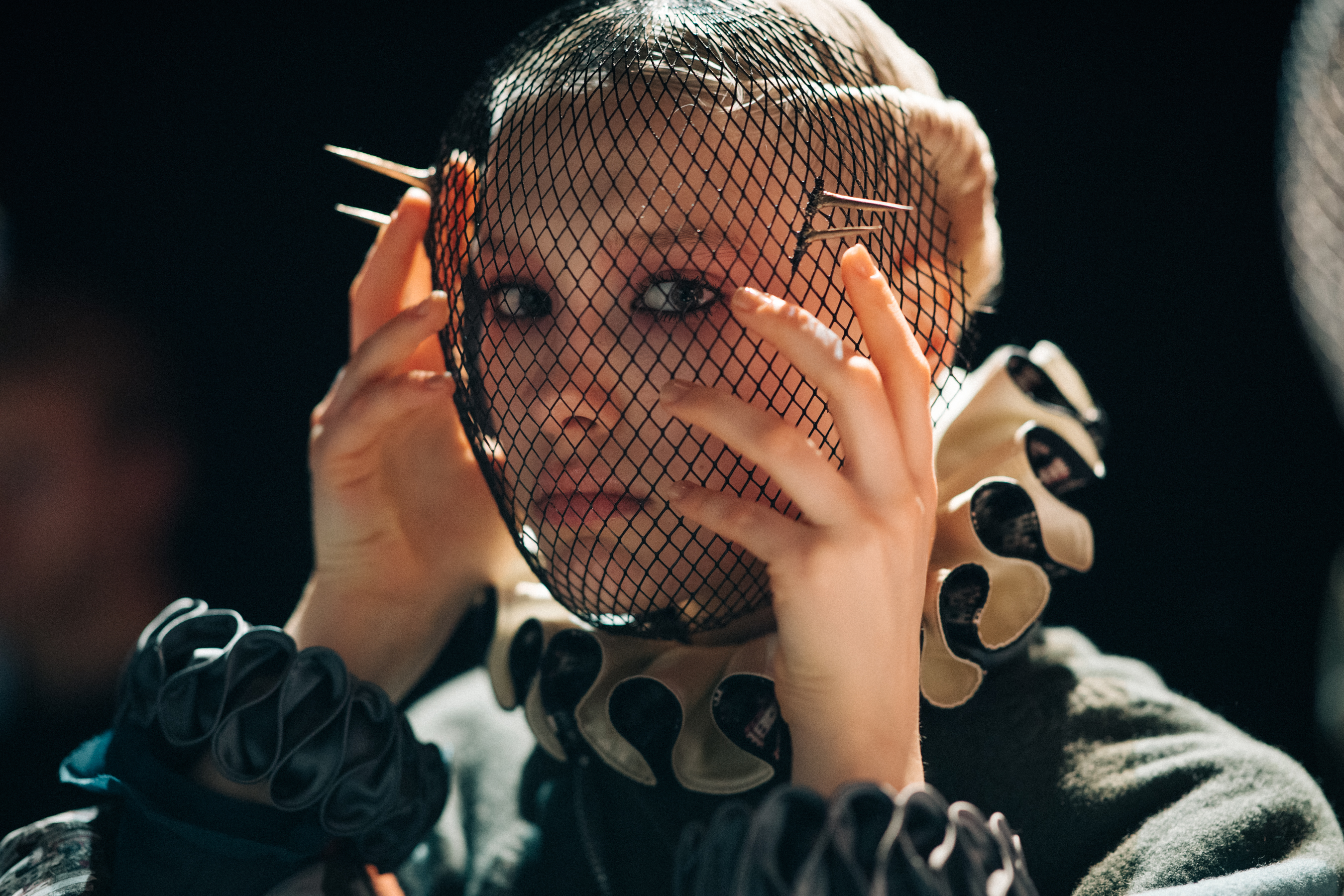 Model wearing fencing mask