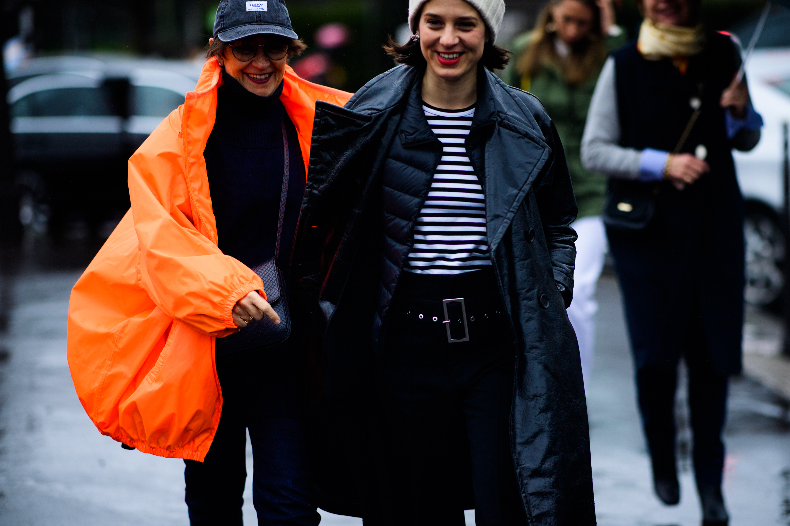 Two women wearing shiny leather coats