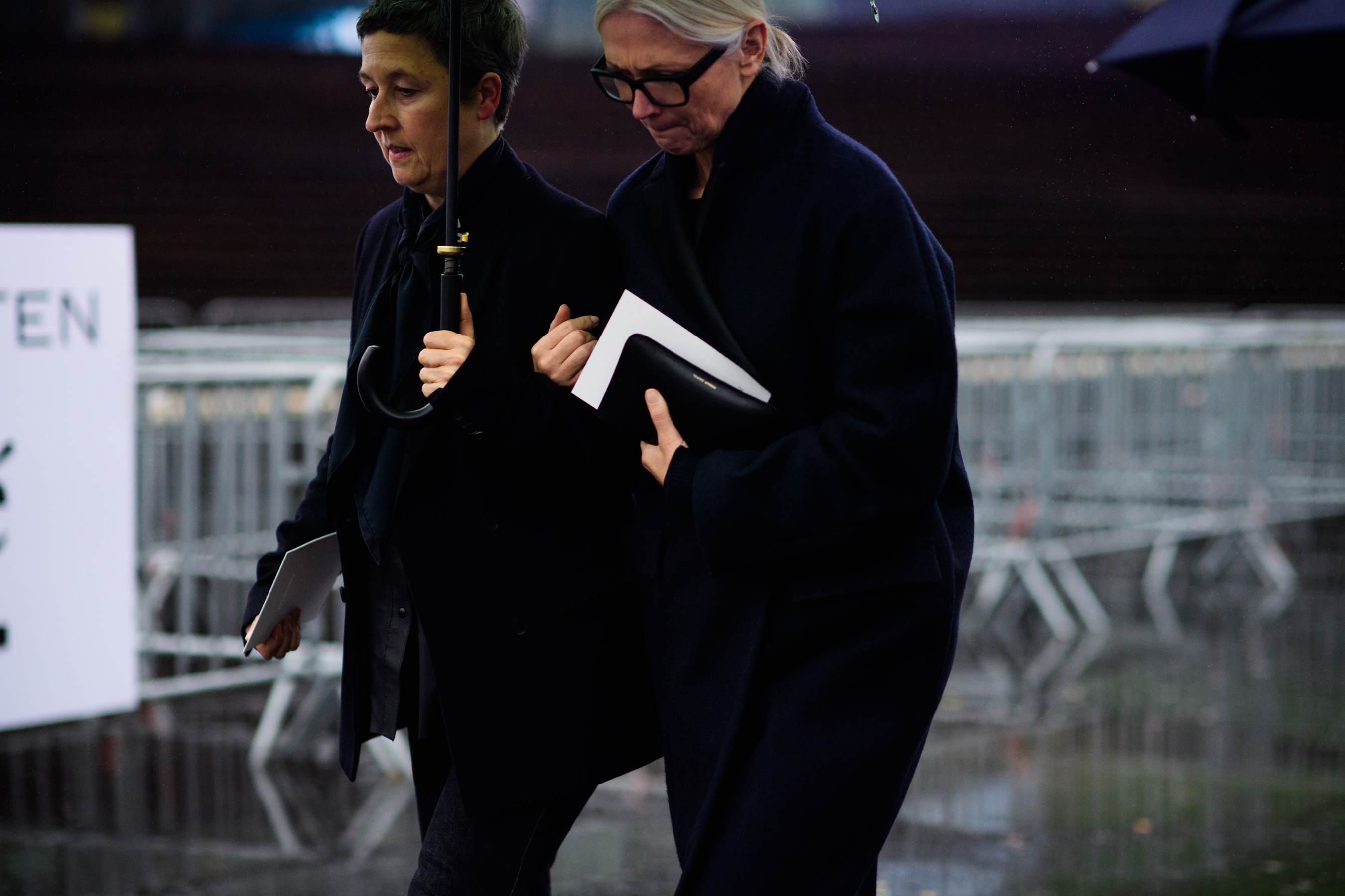 Two women wearing dark clothes