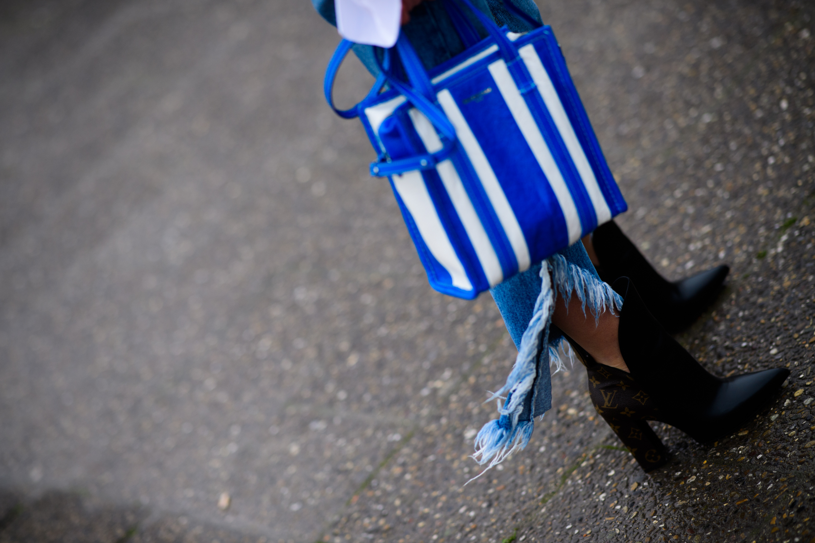 Woman with Balenciaga bag and Louis Vuitton boots