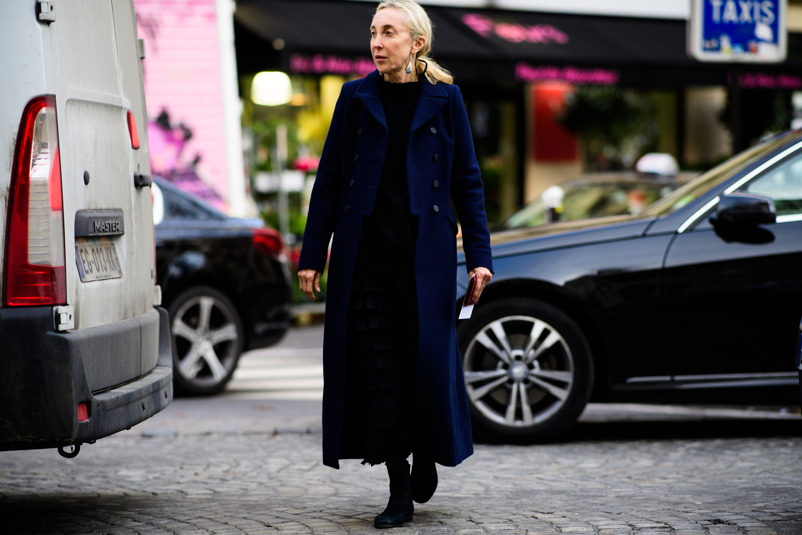 Italian woman wearing long blue coat