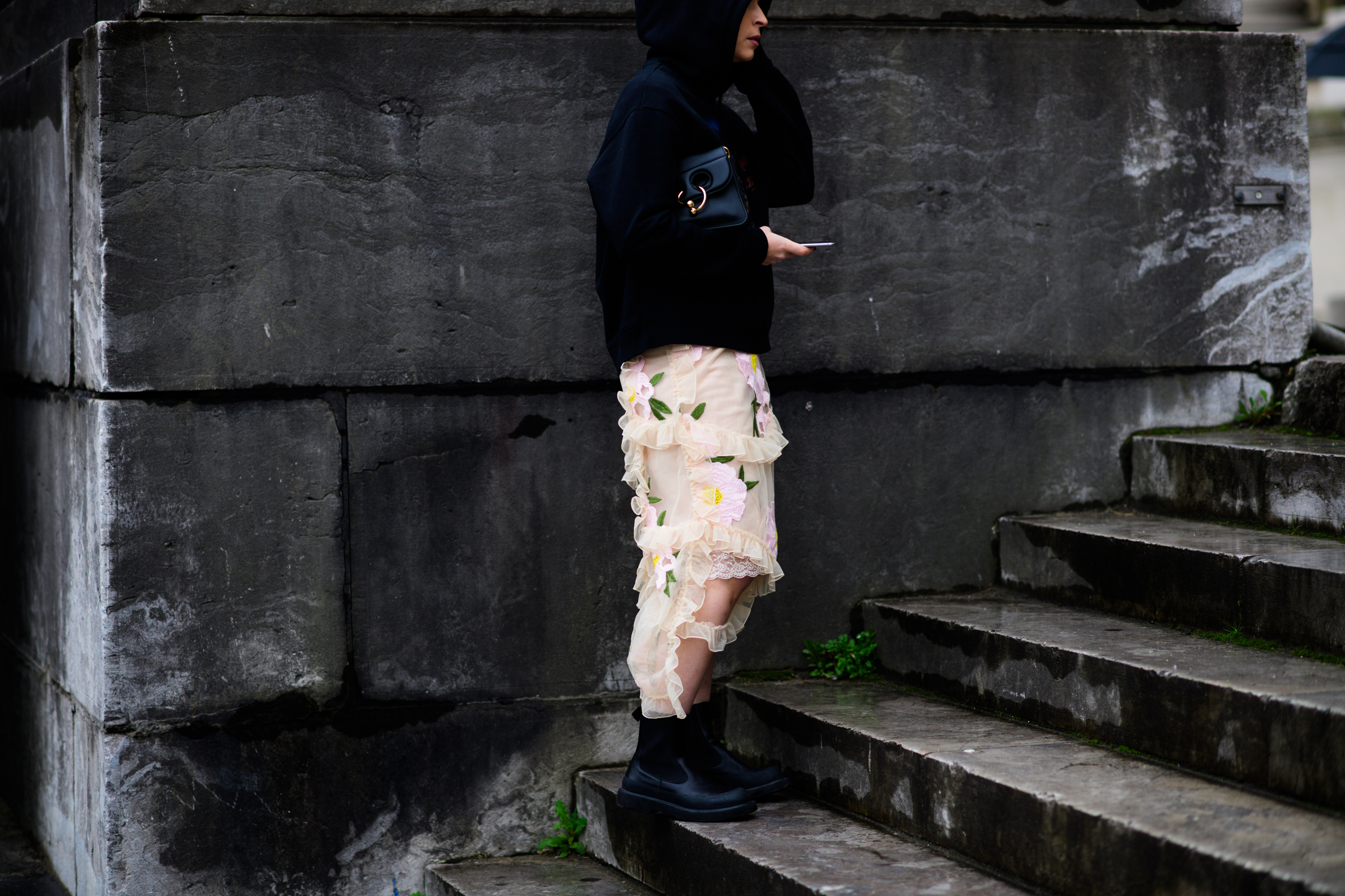 Woman wearing hoodie and floral skirt