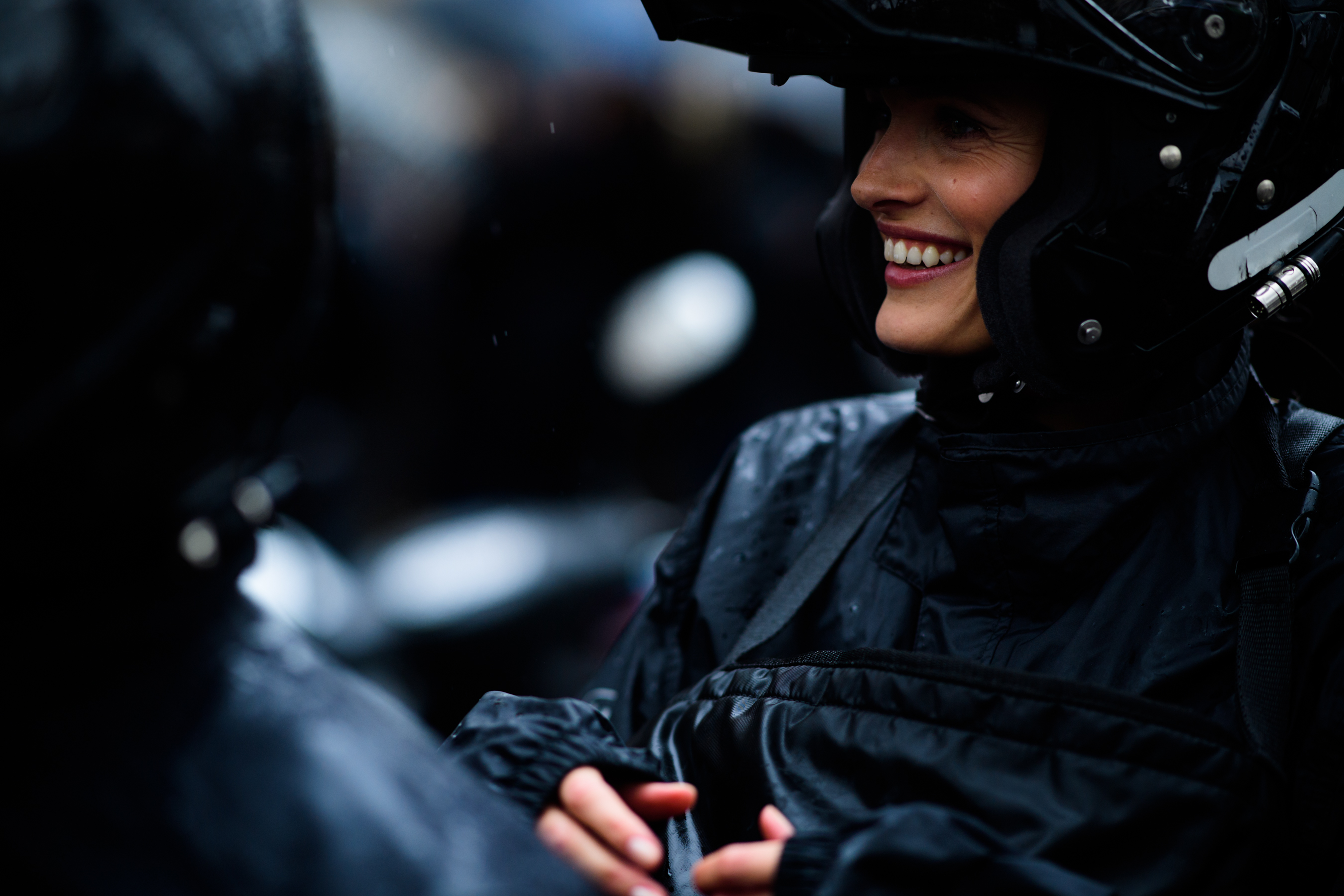 Model wearing all black on a scooter