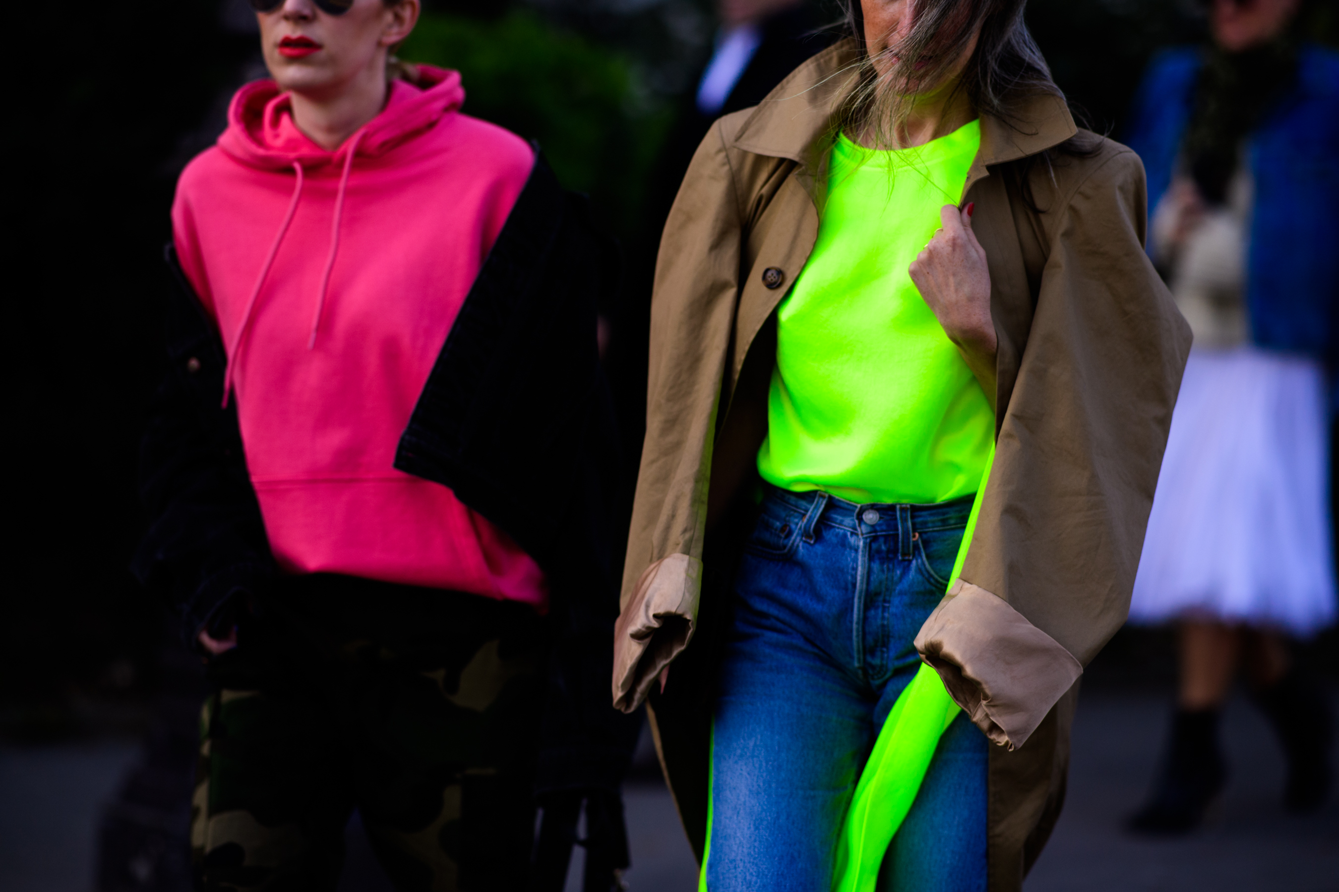Two buyers wearing luminescent hoodies