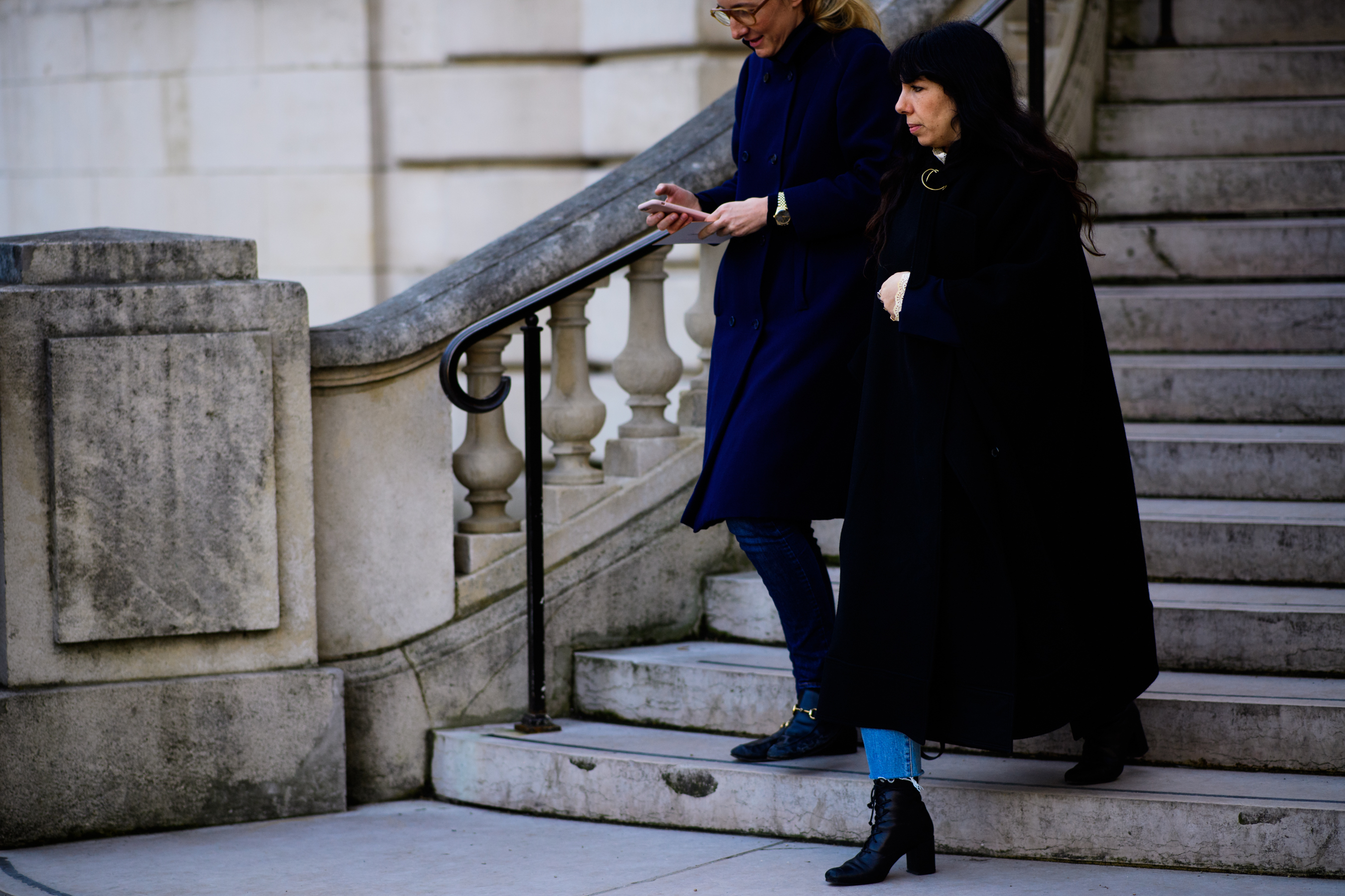 Two women wearing dark clothes