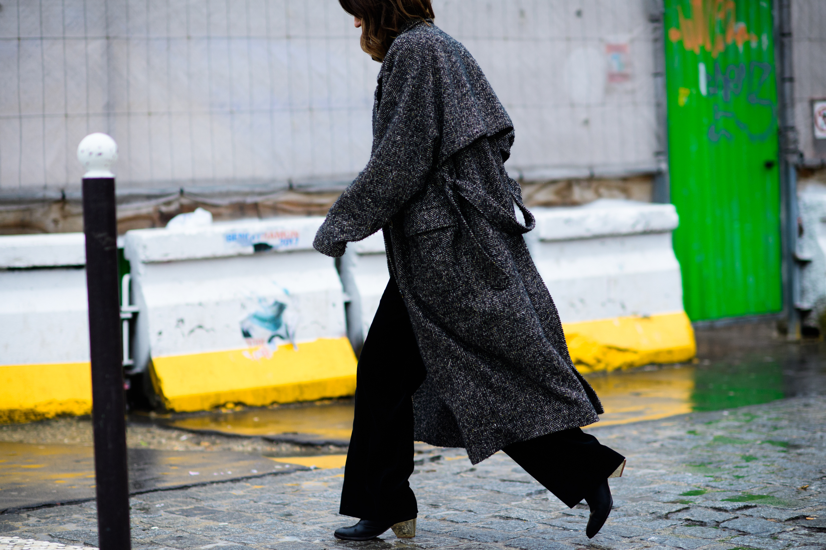 Stylist wearing long black coat