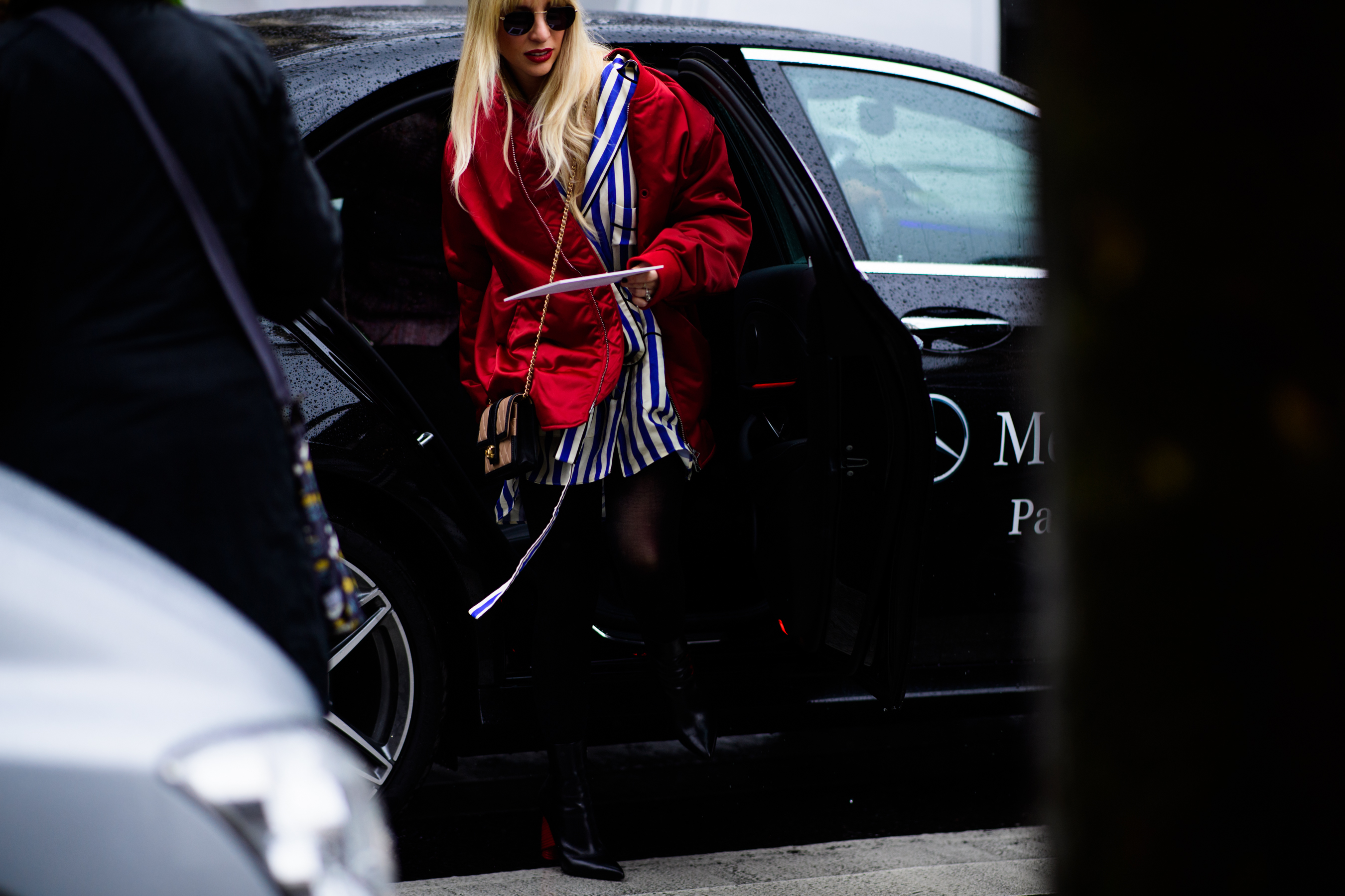 Woman wearing red oversized bomber