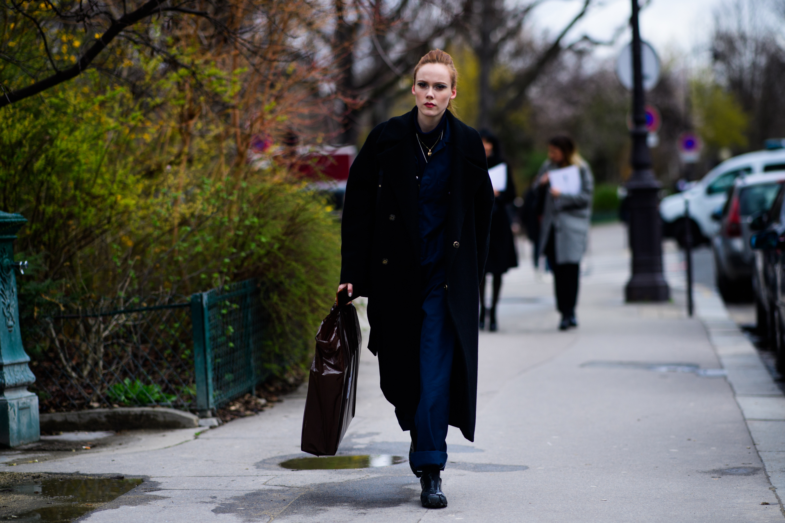 Model wearing long black coat