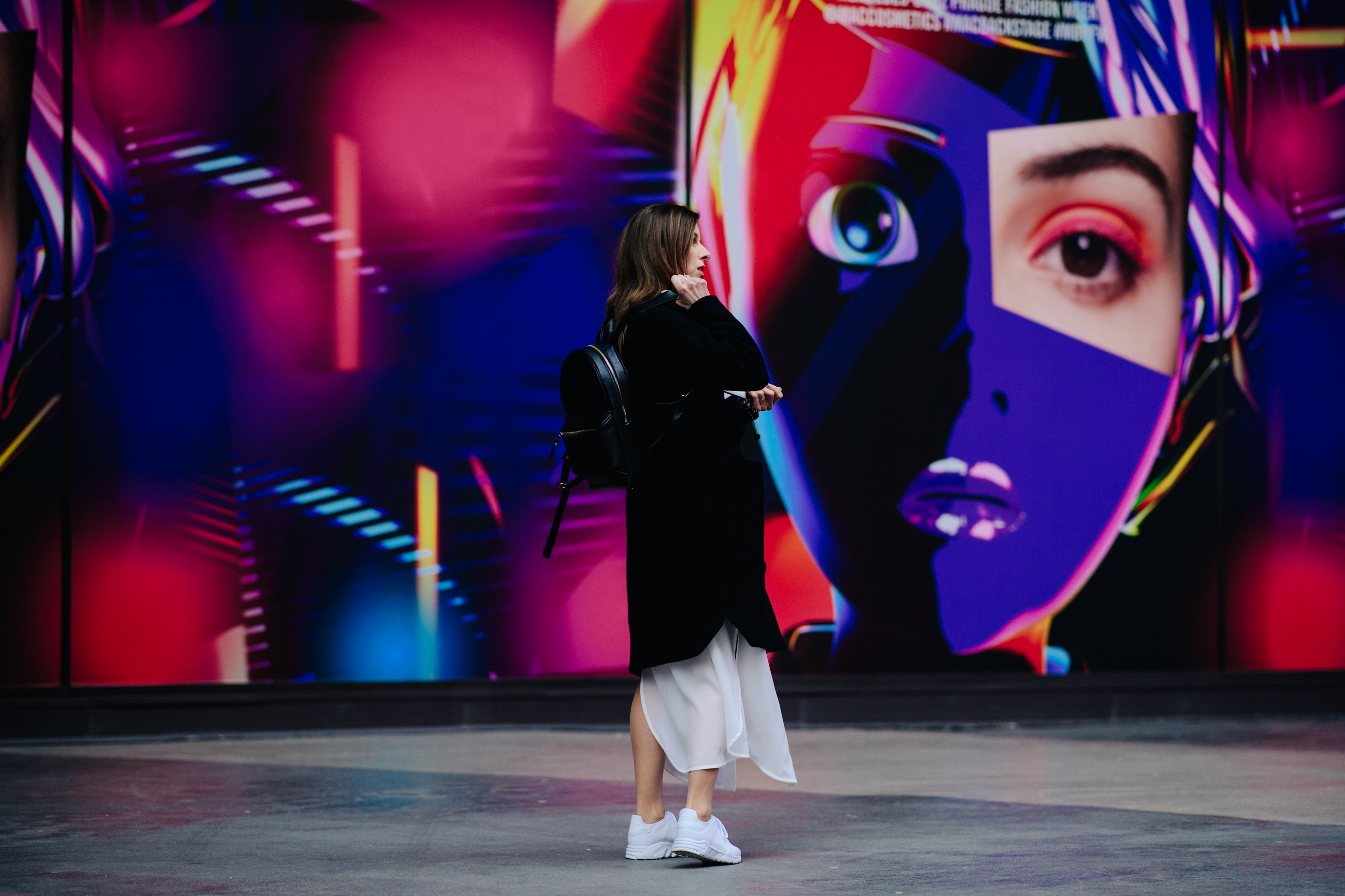 Girl wearing white skirt and sneakers
