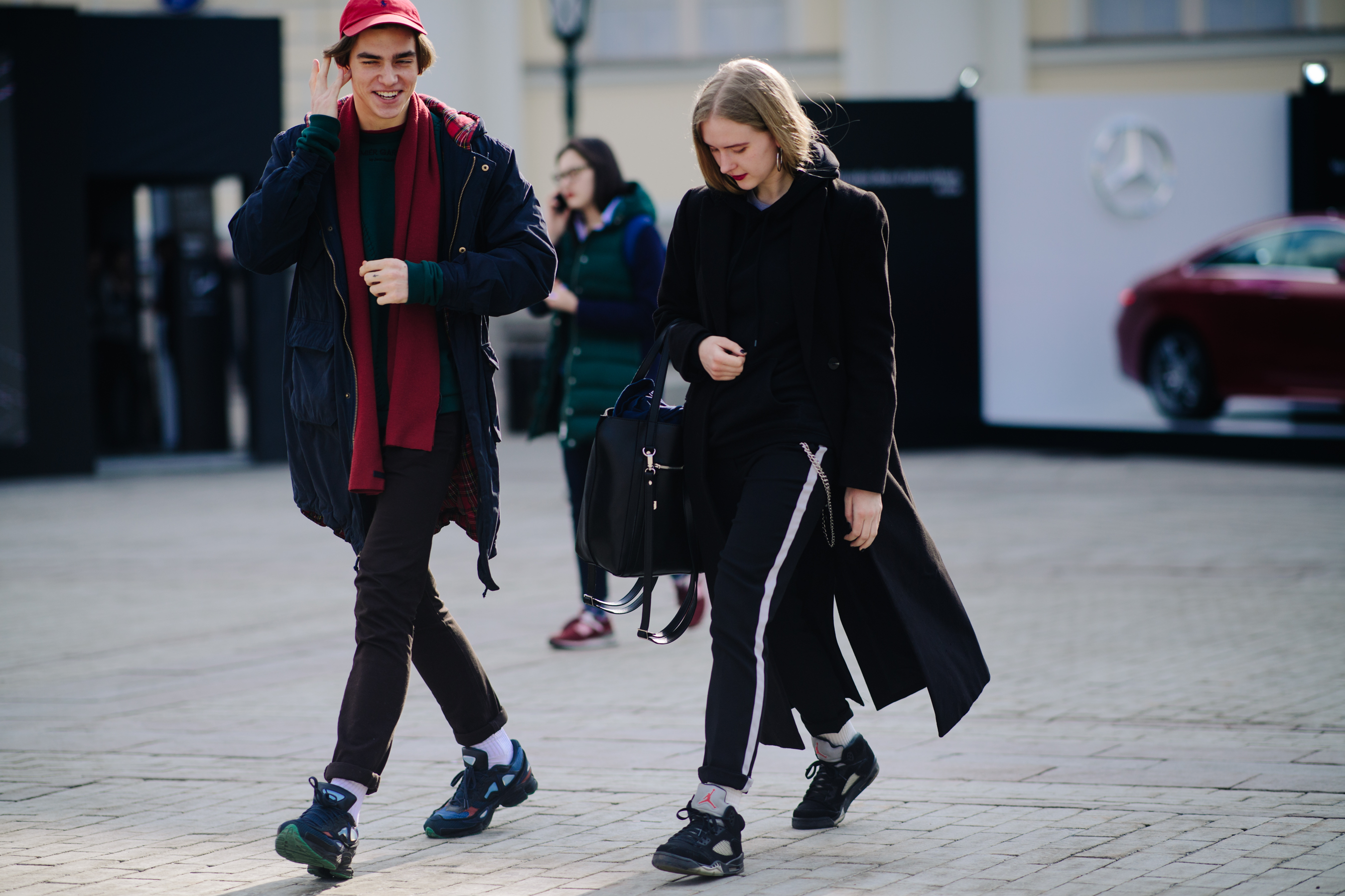 Boy and girl wearing Adidas x Raf Simons
